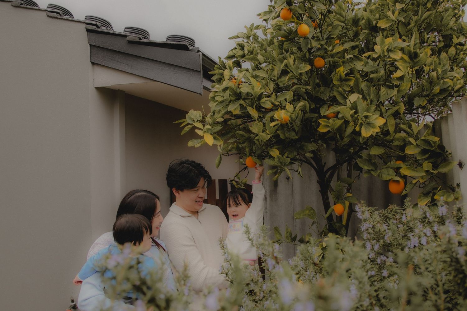 In-home family photoshoot in Singapore capturing candid moments between parents and children at home