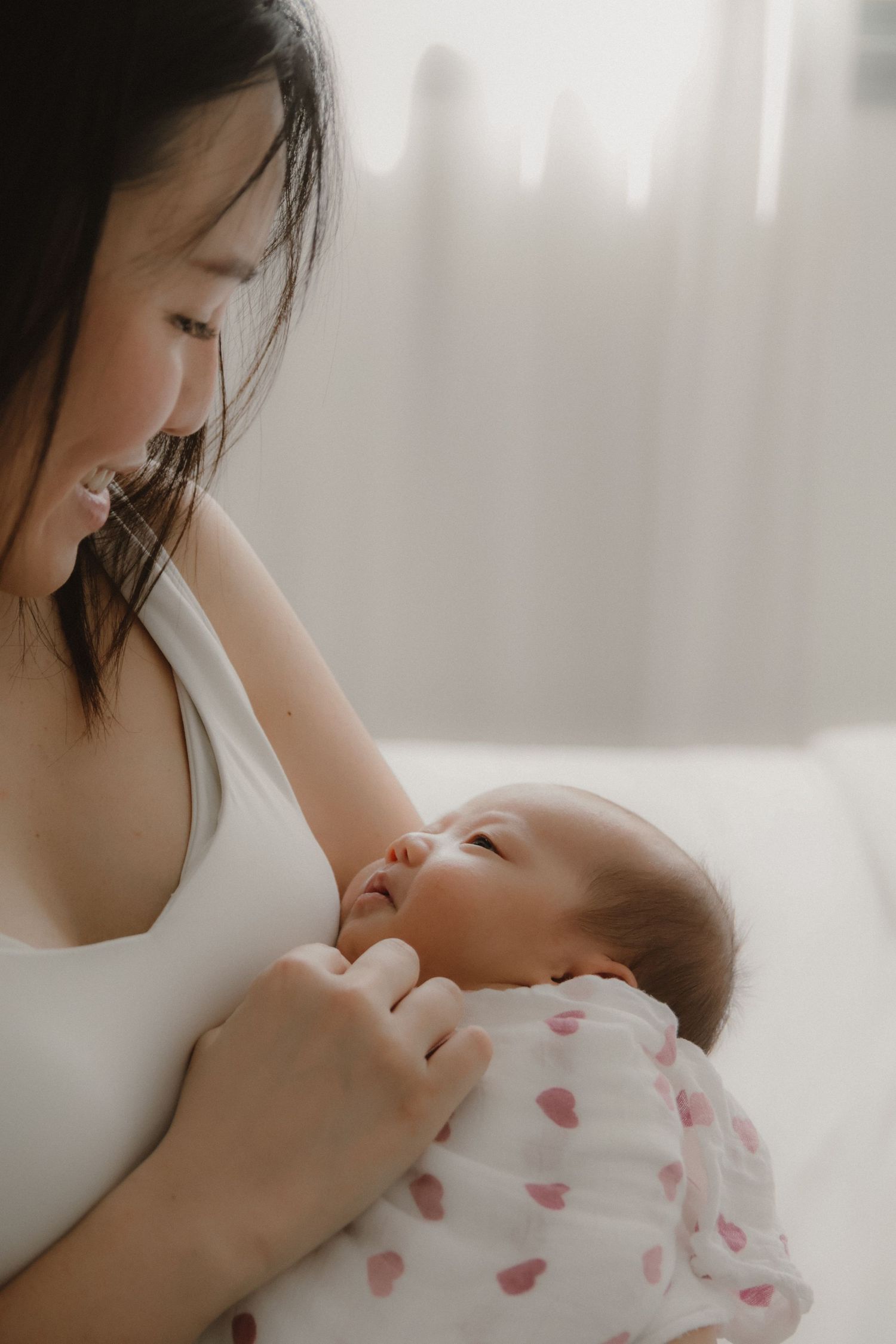 In-home newborn photography in Singapore documenting early days with soft natural light at home