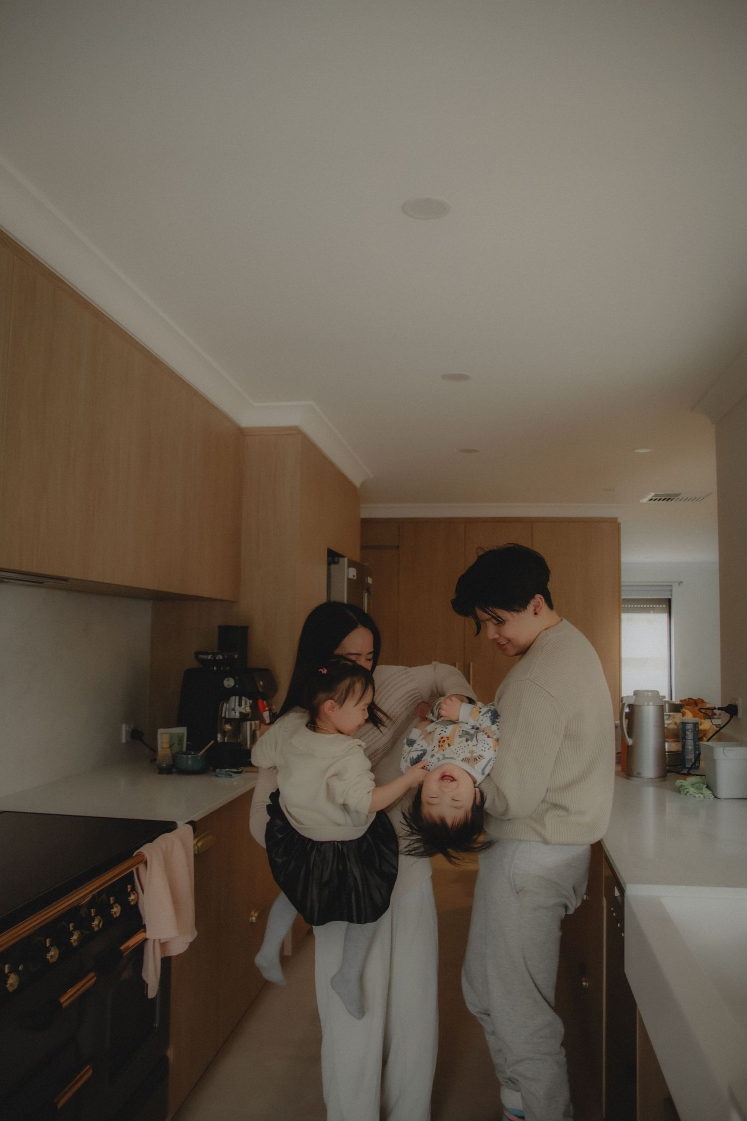 In-home family photoshoot in Singapore capturing candid moments between parents and children at home