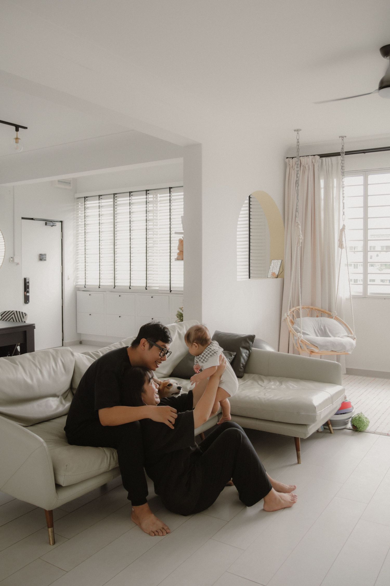 In-home family of 3 photoshoot in Singapore capturing candid moments between parents and children at home with natural lighting, and pet dog