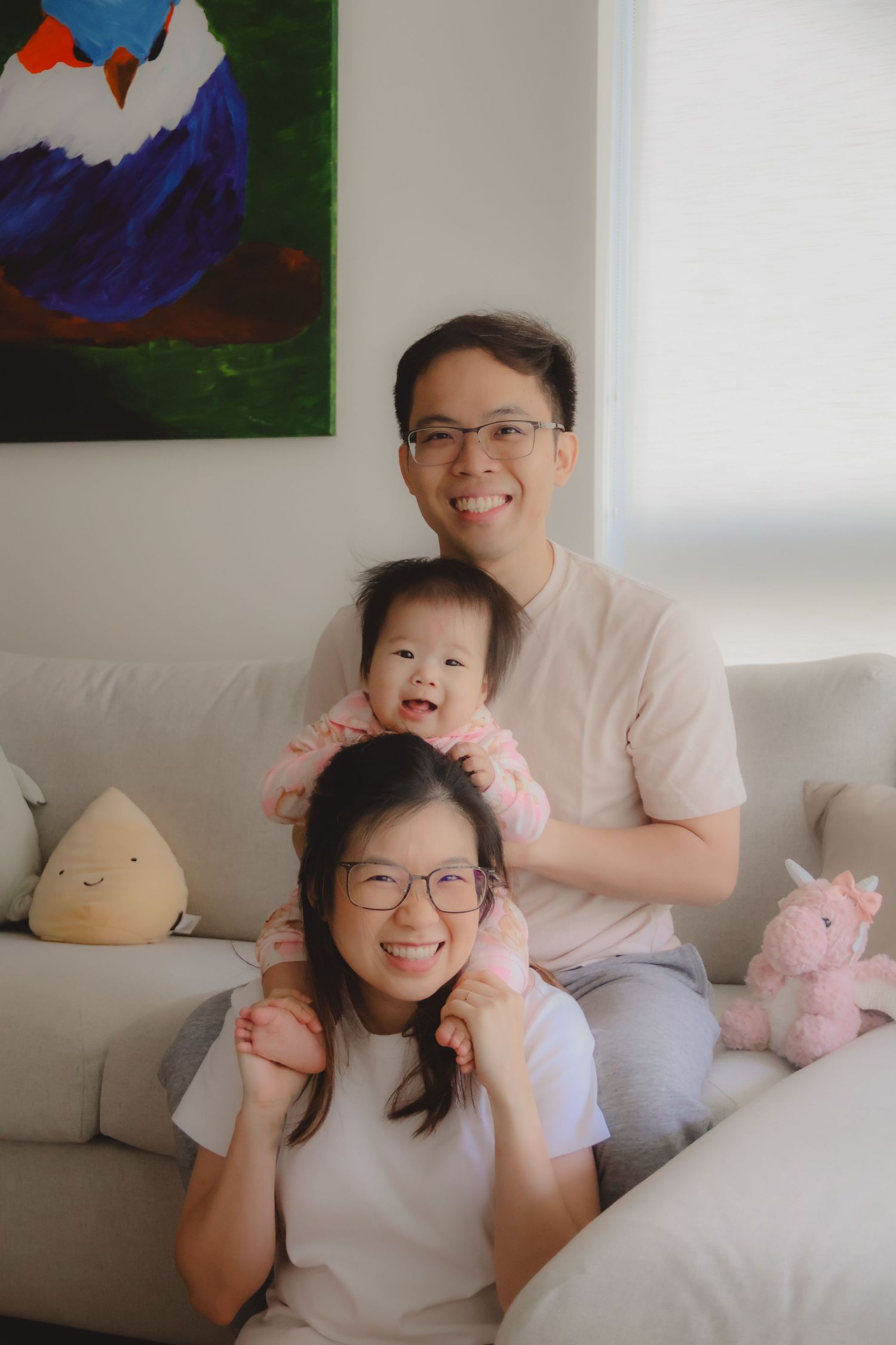 In-home family of 3 photoshoot in Singapore capturing candid moments between parents and children at home with natural lighting