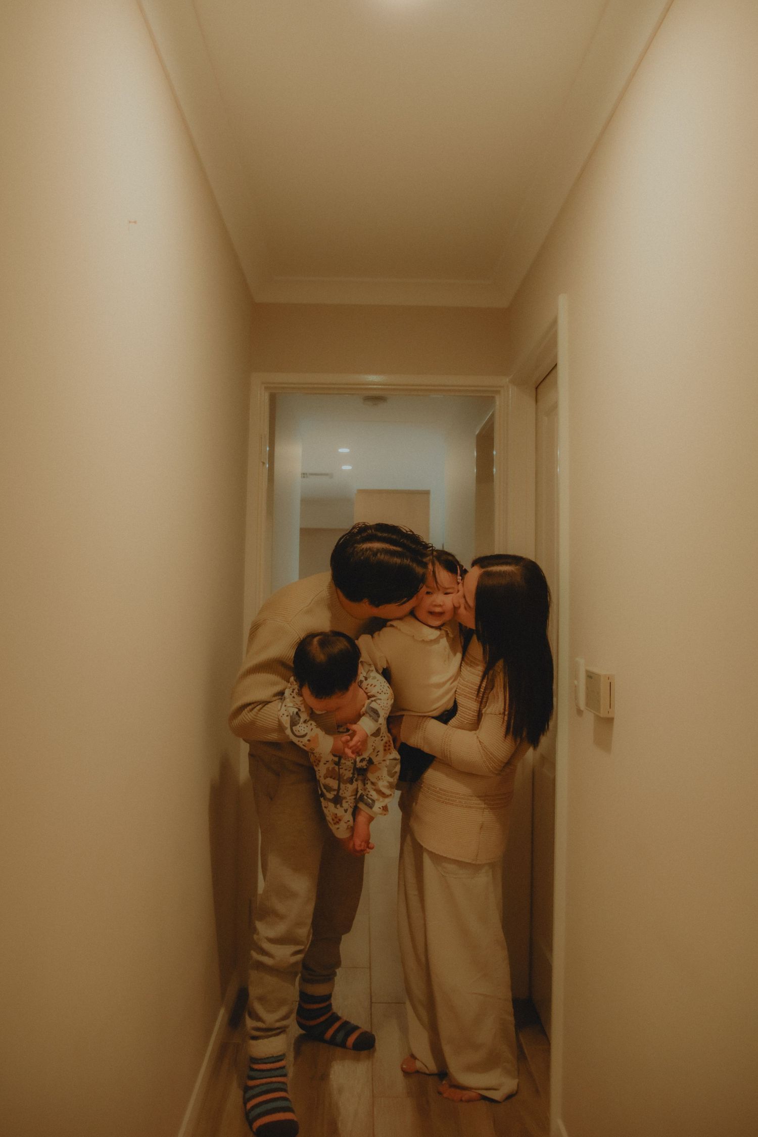 In-home family photoshoot in Singapore capturing candid moments between parents and children at home