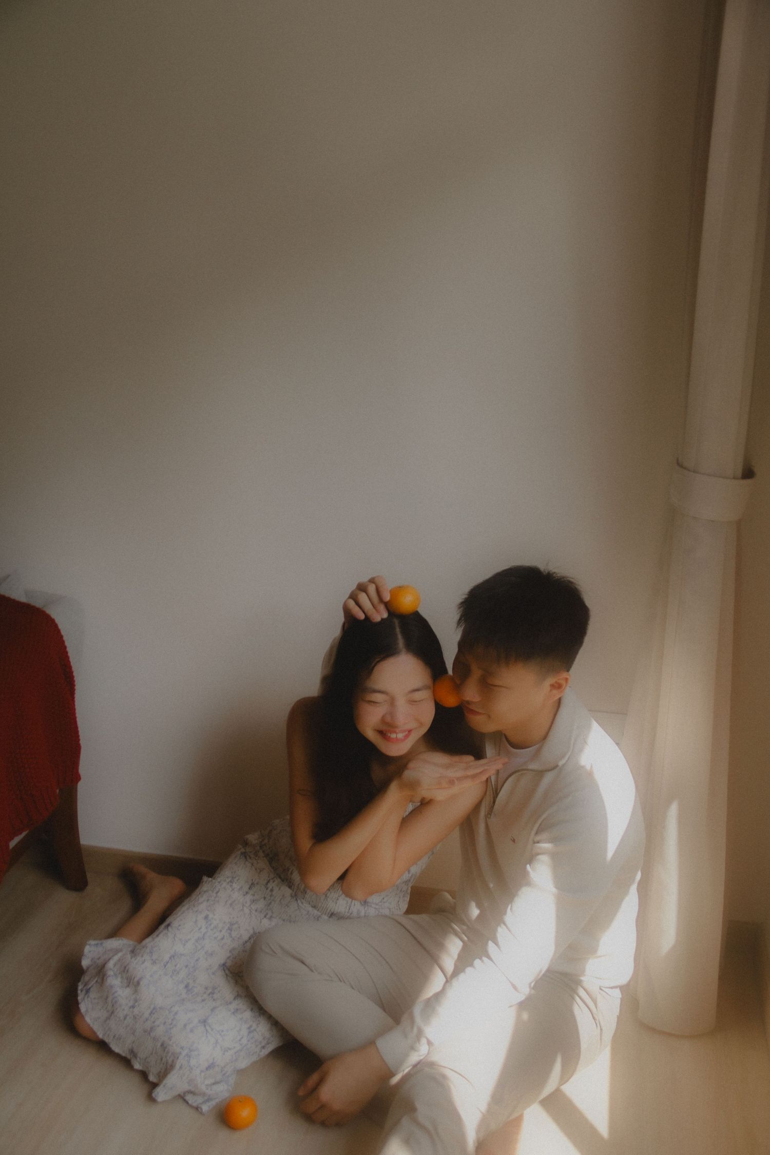 In-home couple photoshoot in Singapore with warm, natural light and storytelling focus