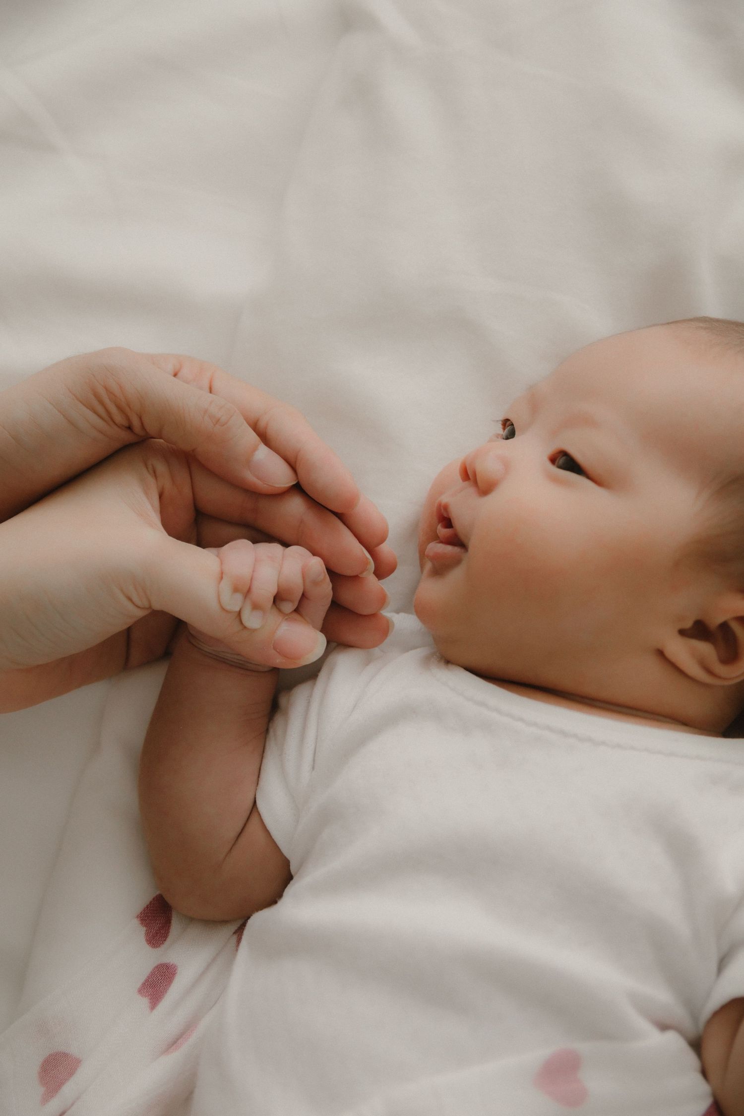 In-home newborn photography in Singapore documenting early days with soft natural light at home