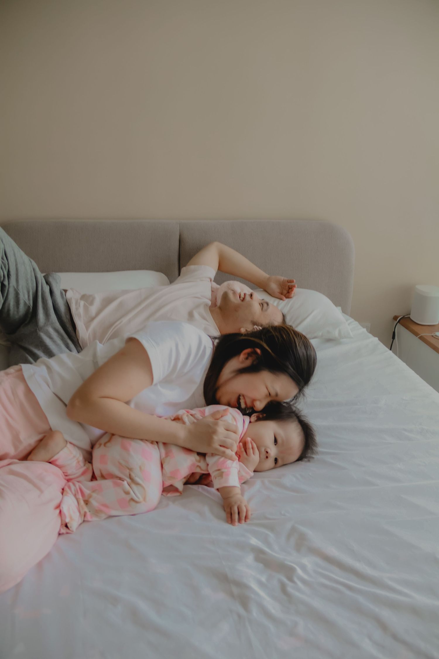 In-home family of 3 photoshoot in Singapore capturing candid moments between parents and children at home with natural lighting