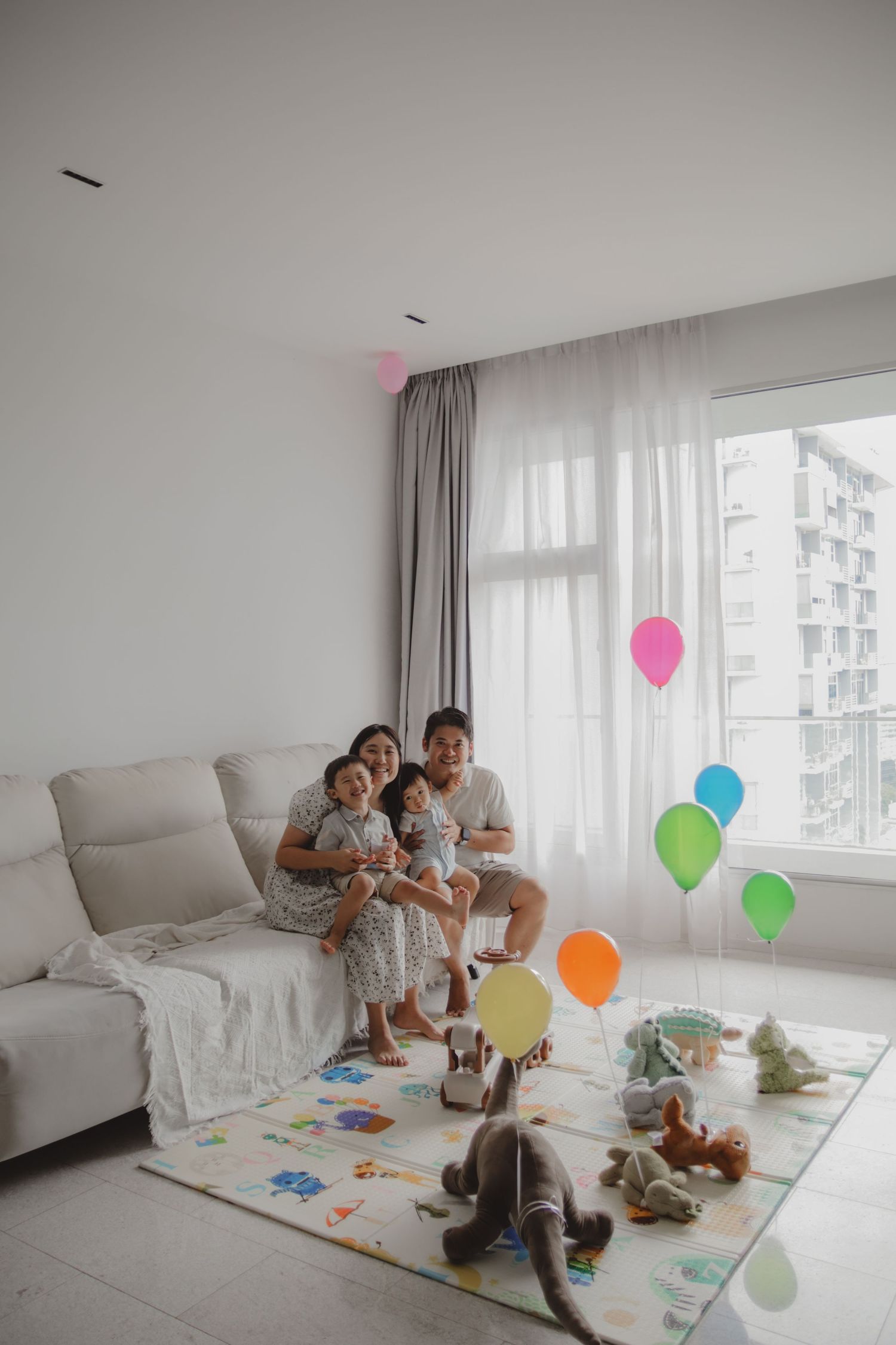 In-home family of 4 photoshoot in Singapore capturing candid moments between parents and children at home with natural lighting