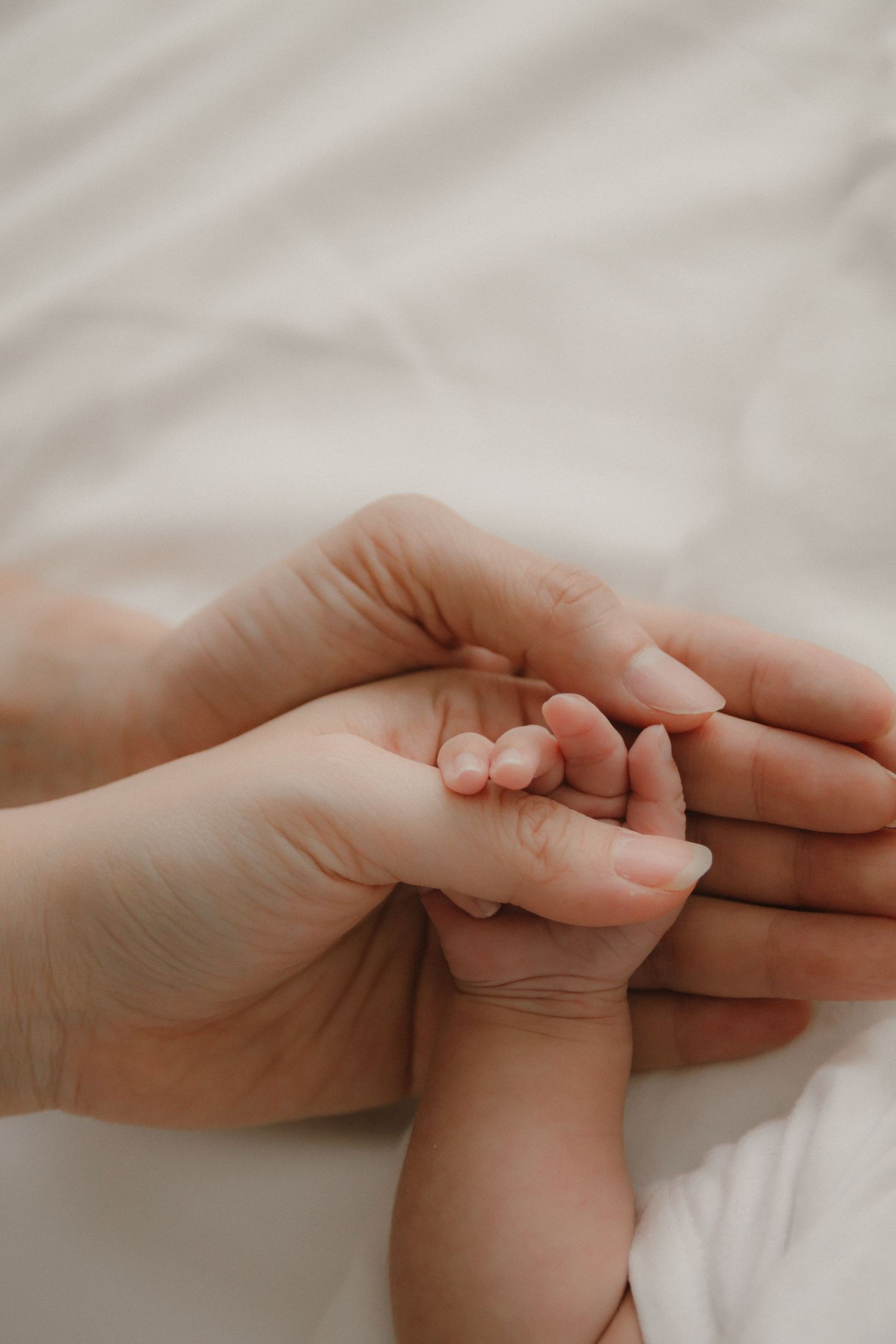 In-home newborn photography in Singapore documenting early days with soft natural light at home