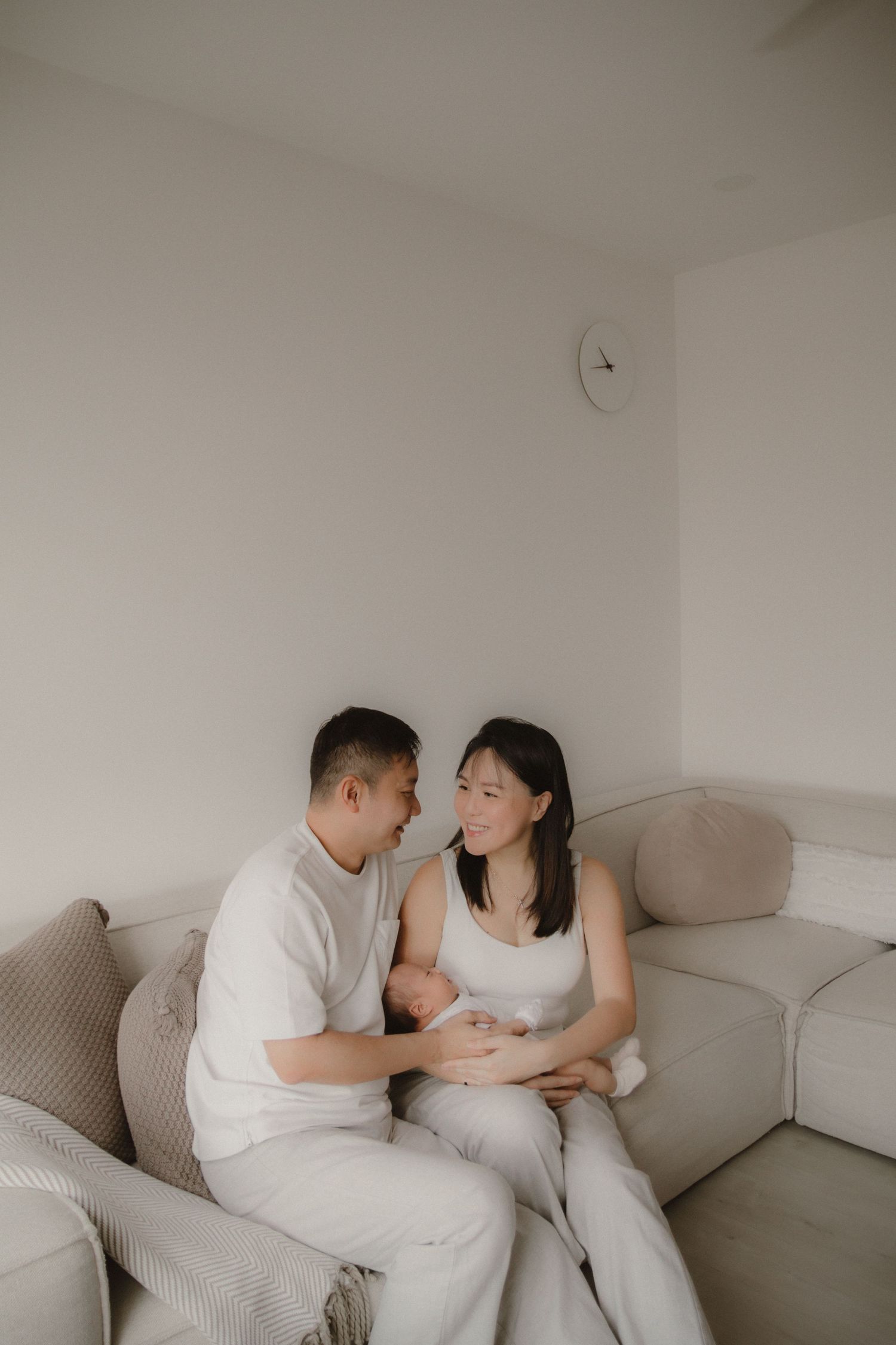 In-home newborn photography in Singapore documenting early days with soft natural light at home