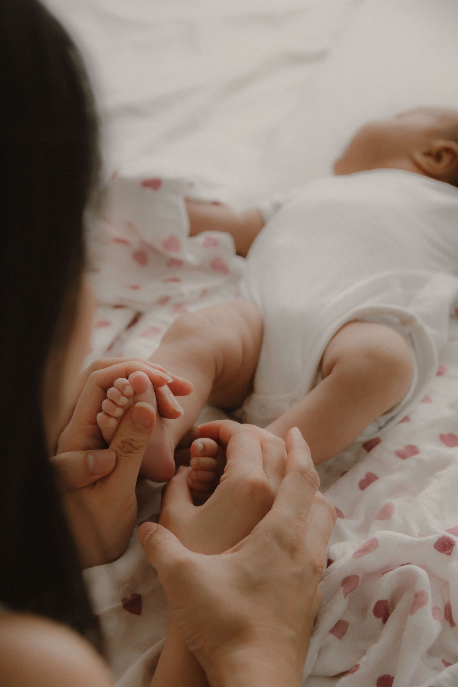 In-home newborn photography in Singapore documenting early days with soft natural light at home