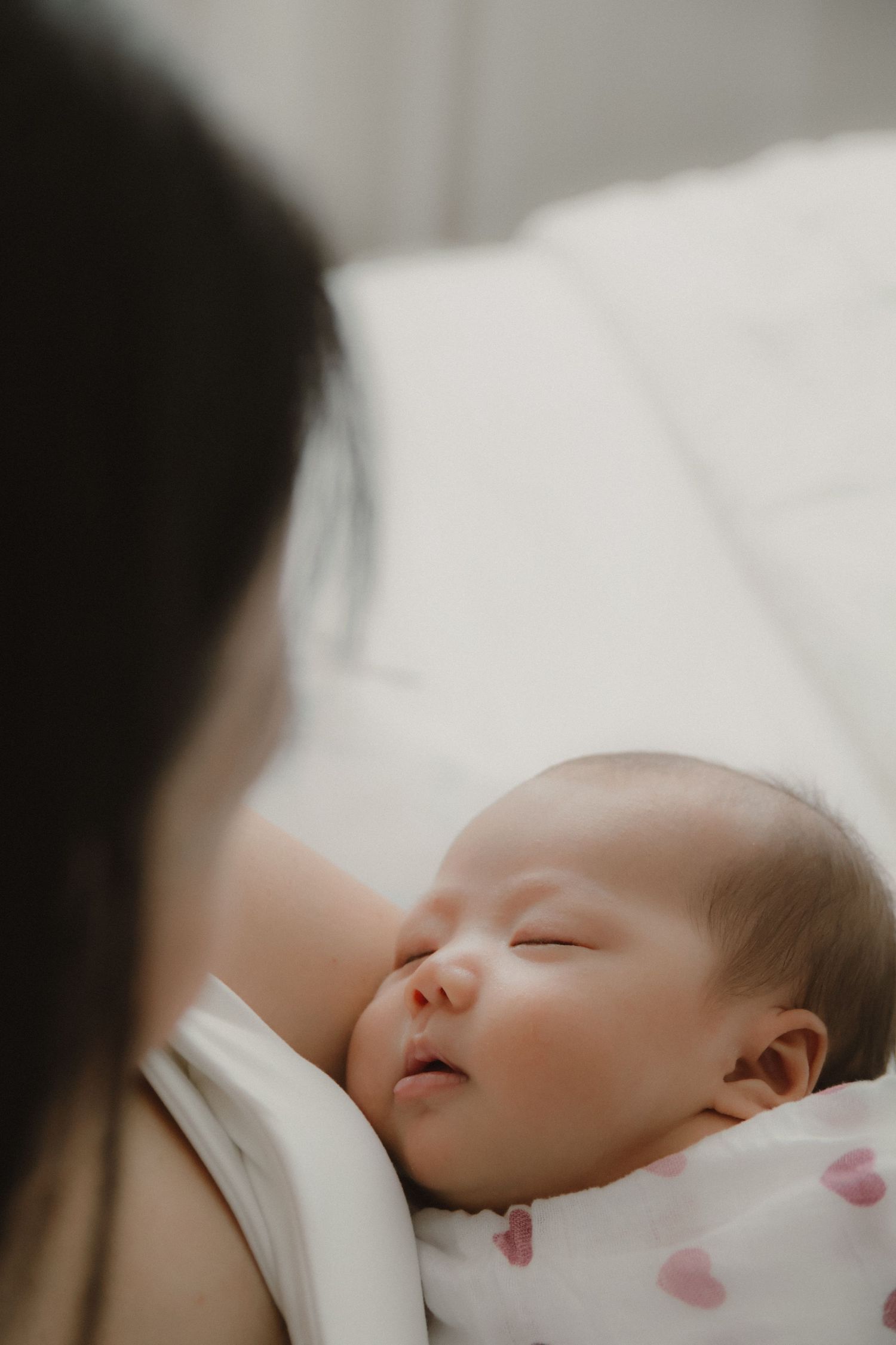 In-home newborn photography in Singapore documenting early days with soft natural light at home