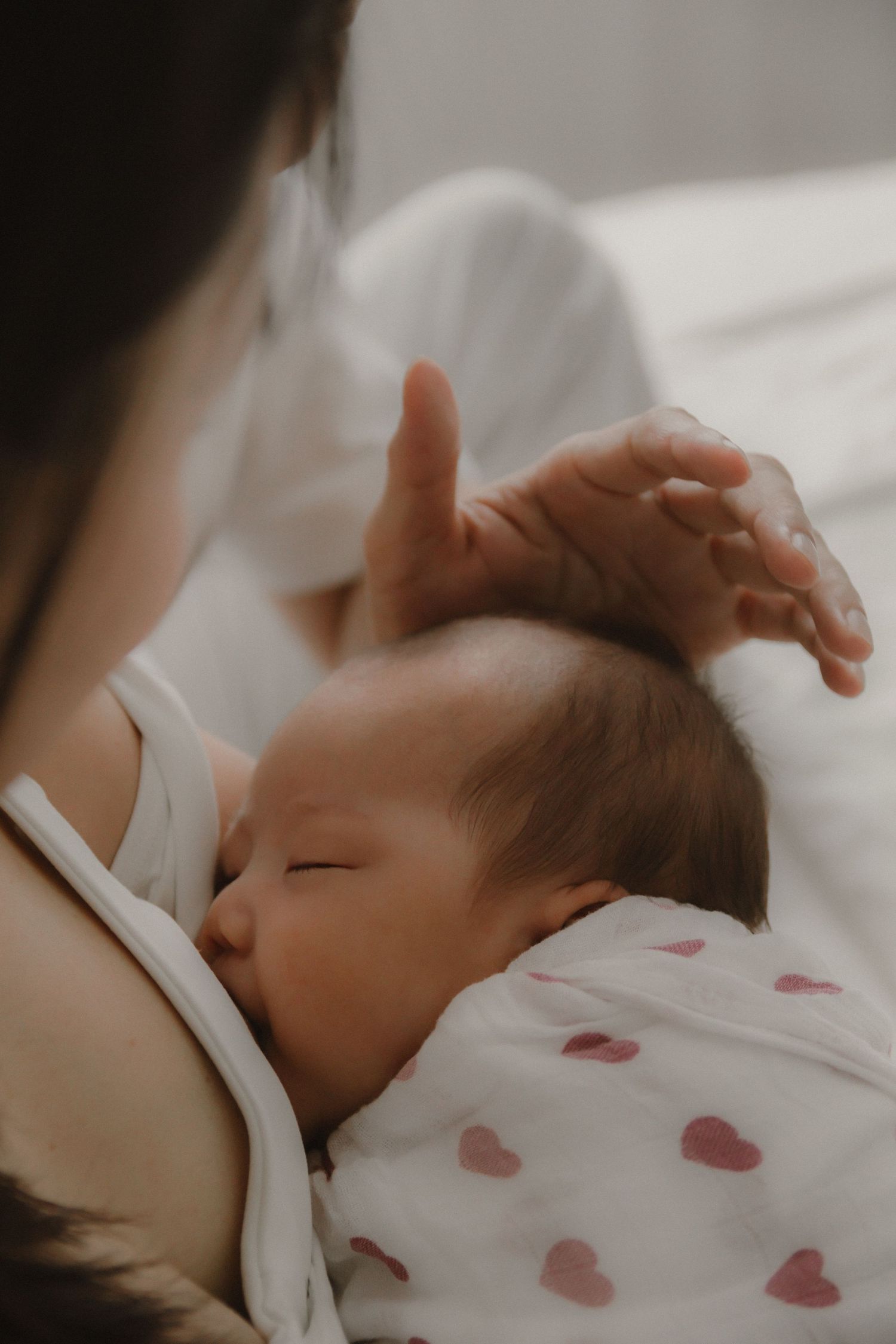 In-home newborn photography in Singapore documenting early days with soft natural light at home