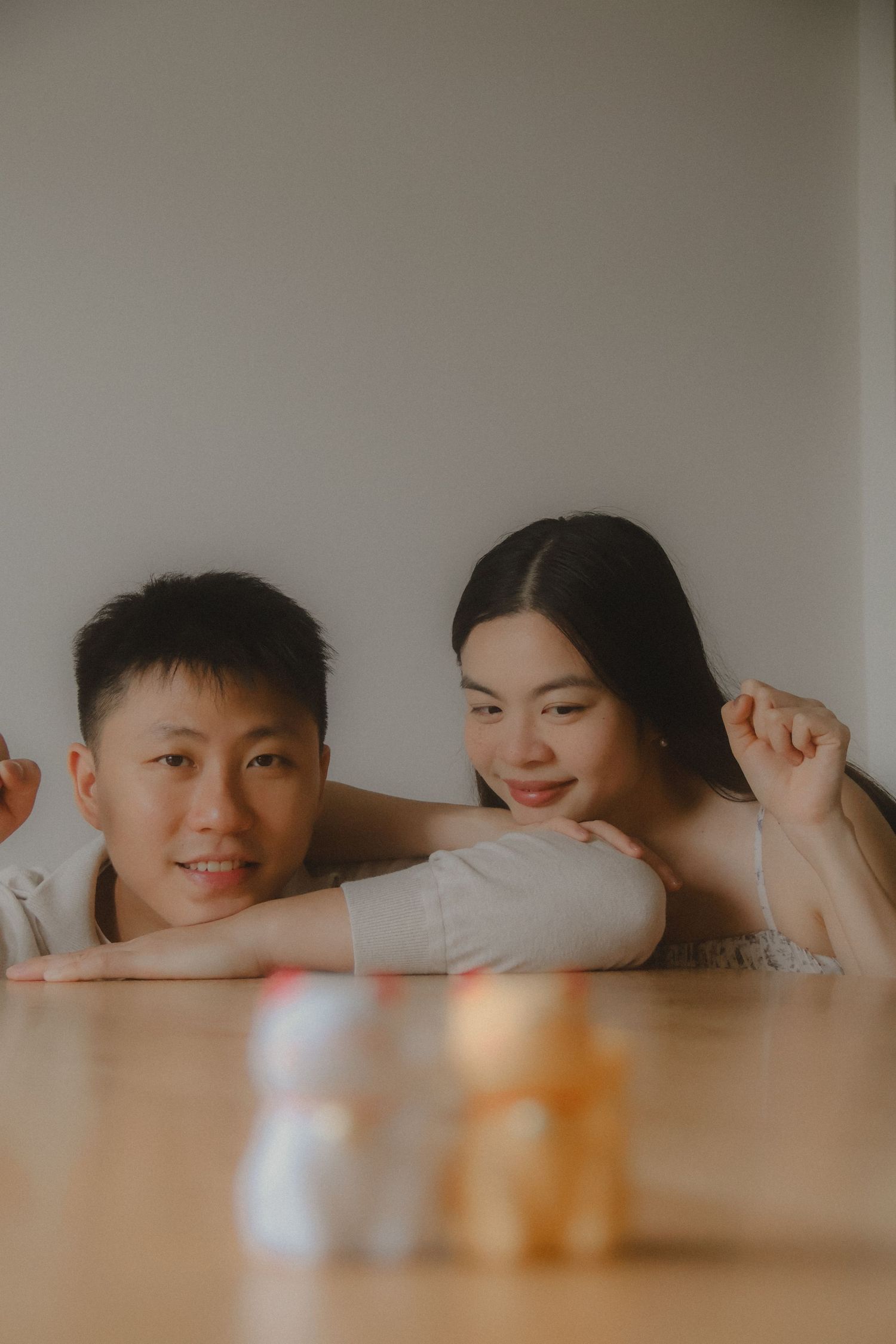 In-home couple photoshoot in Singapore with warm, natural light and storytelling focus