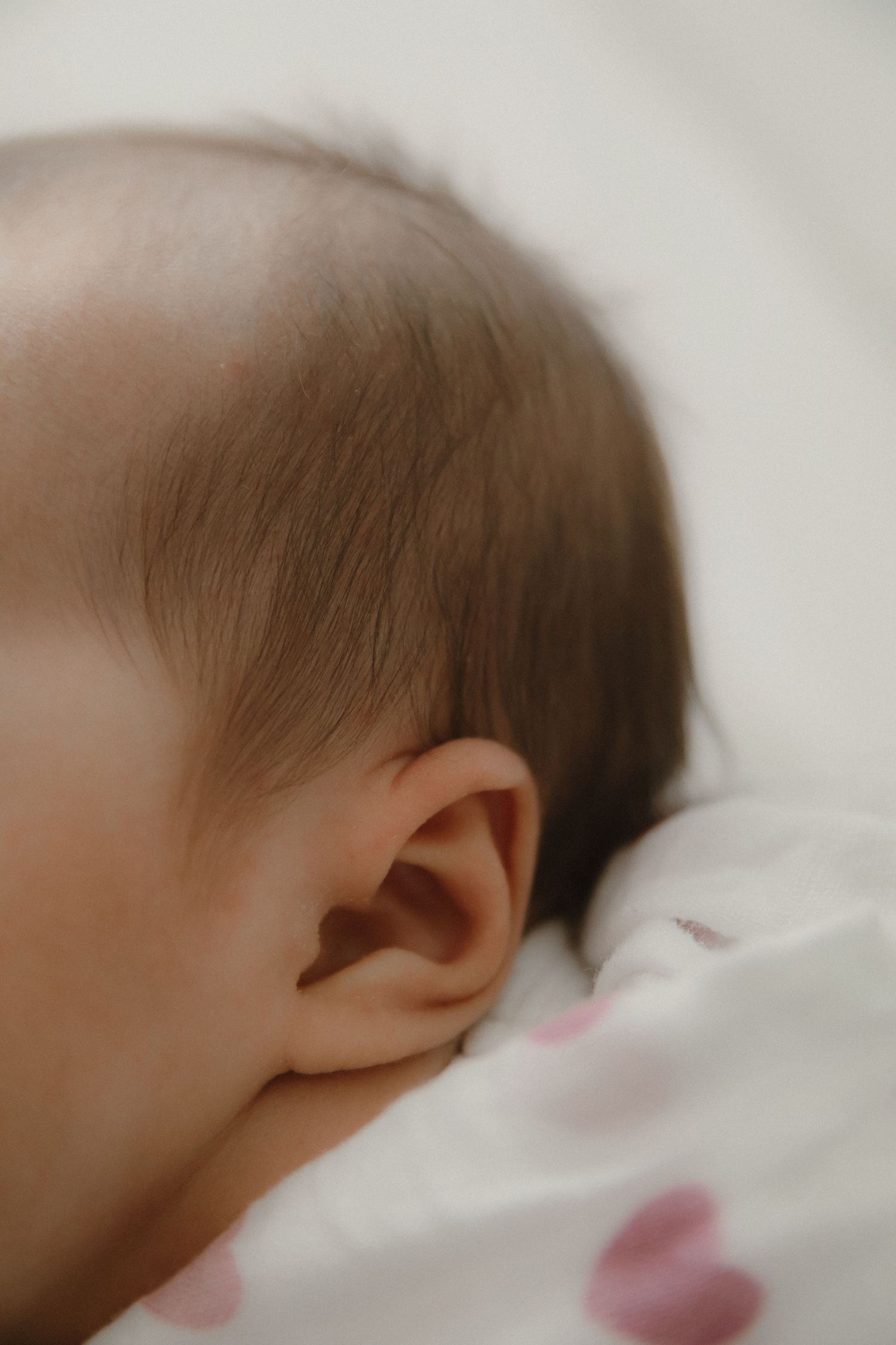In-home newborn photography in Singapore documenting early days with soft natural light at home