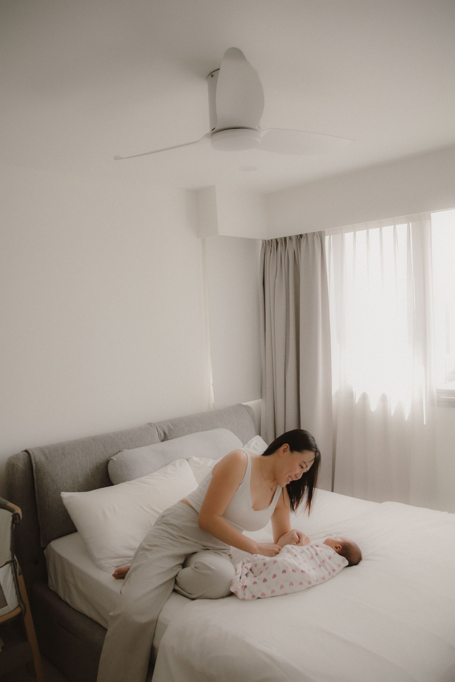 In-home newborn photography in Singapore documenting early days with soft natural light at home