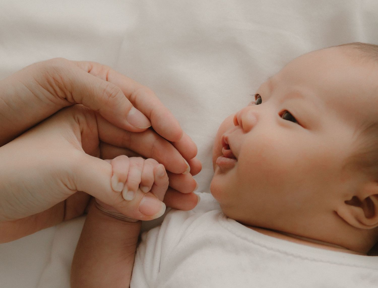 In-home newborn photography in Singapore documenting early days with soft natural light at home