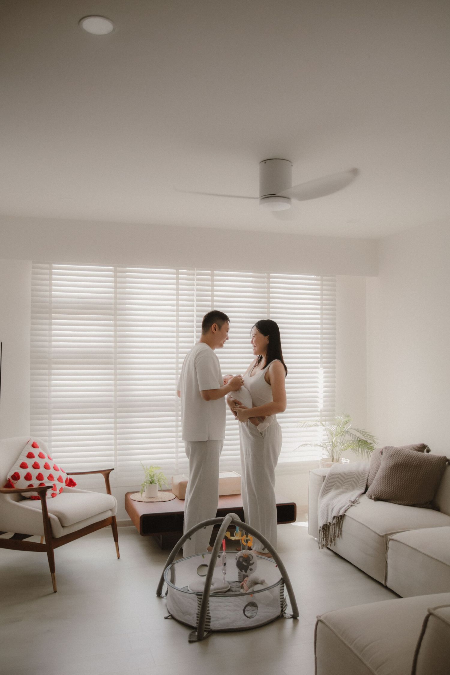 In-home newborn photography in Singapore documenting early days with soft natural light at home