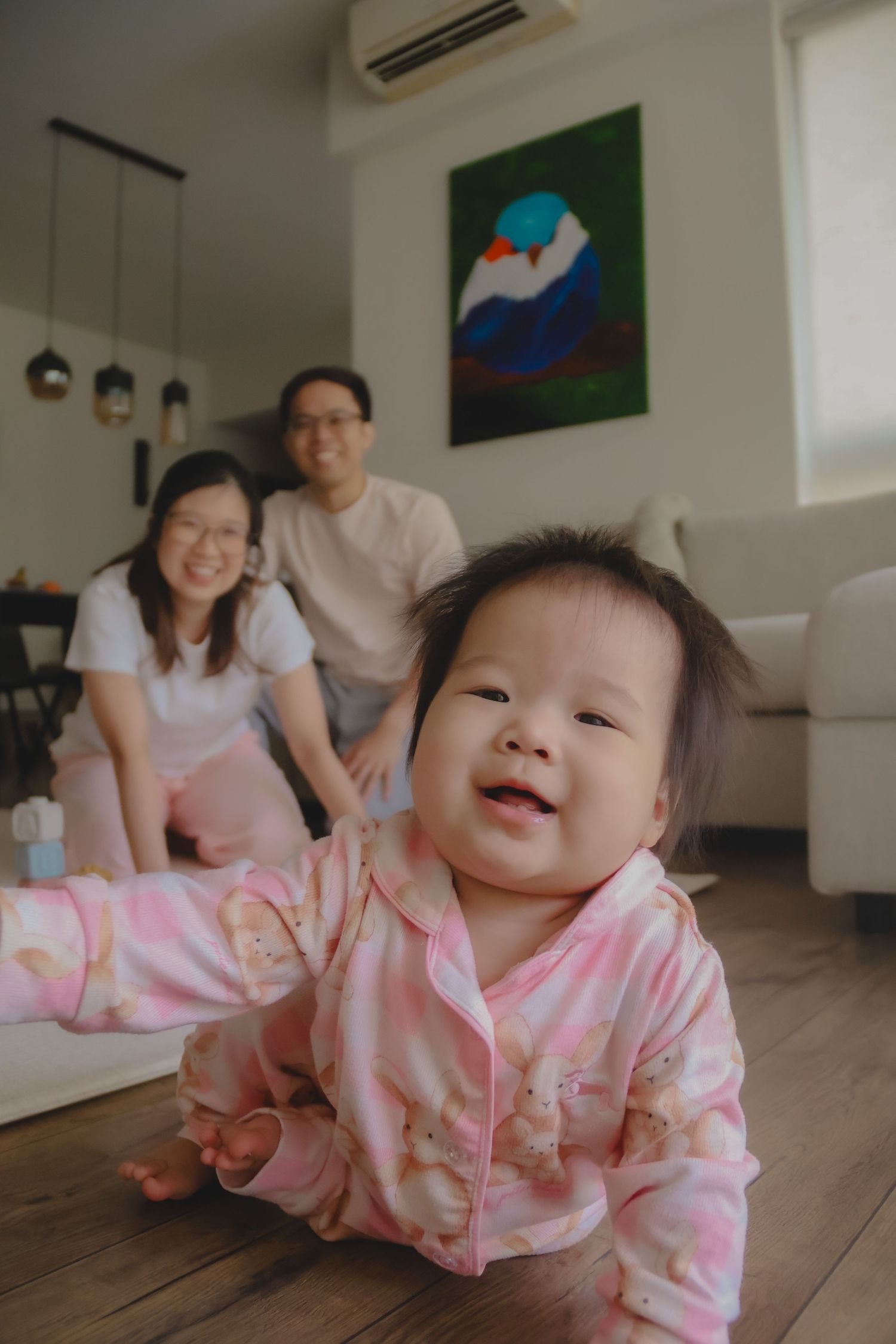 In-home family of 3 photoshoot in Singapore capturing candid moments between parents and children at home with natural lighting