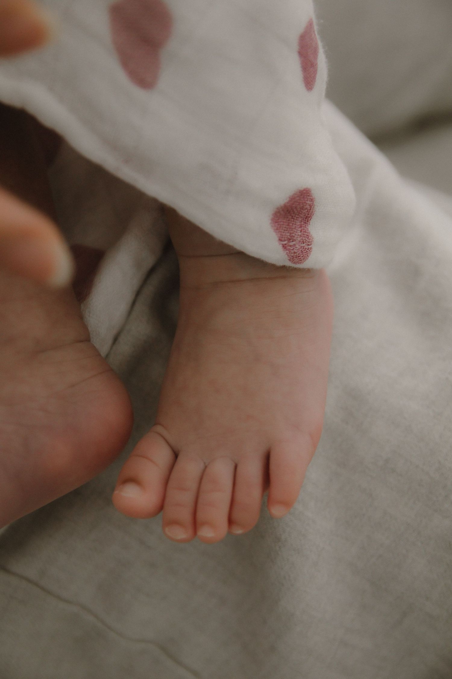 In-home newborn photography in Singapore documenting early days with soft natural light at home