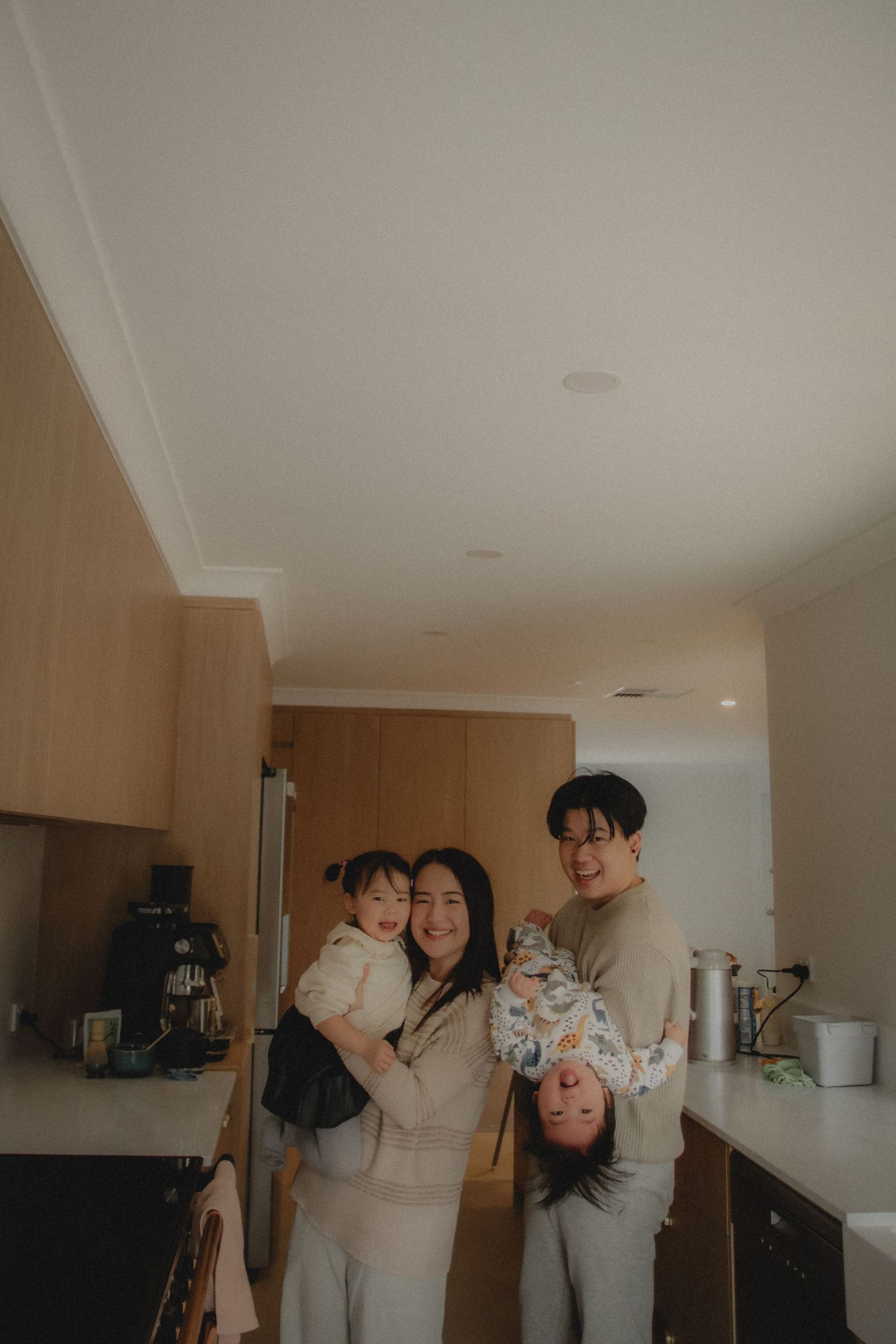 In-home family photoshoot in Singapore capturing candid moments between parents and children at home