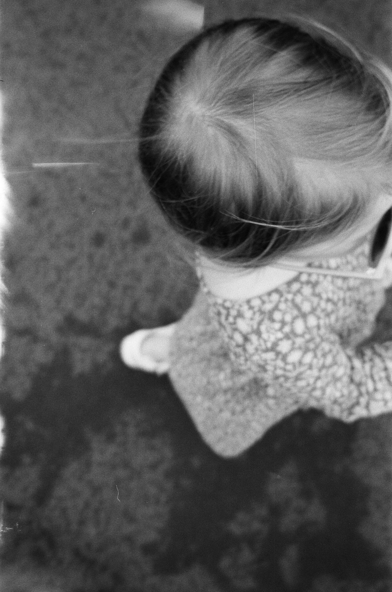 Black and white profile view showing floral pattern collar detail.