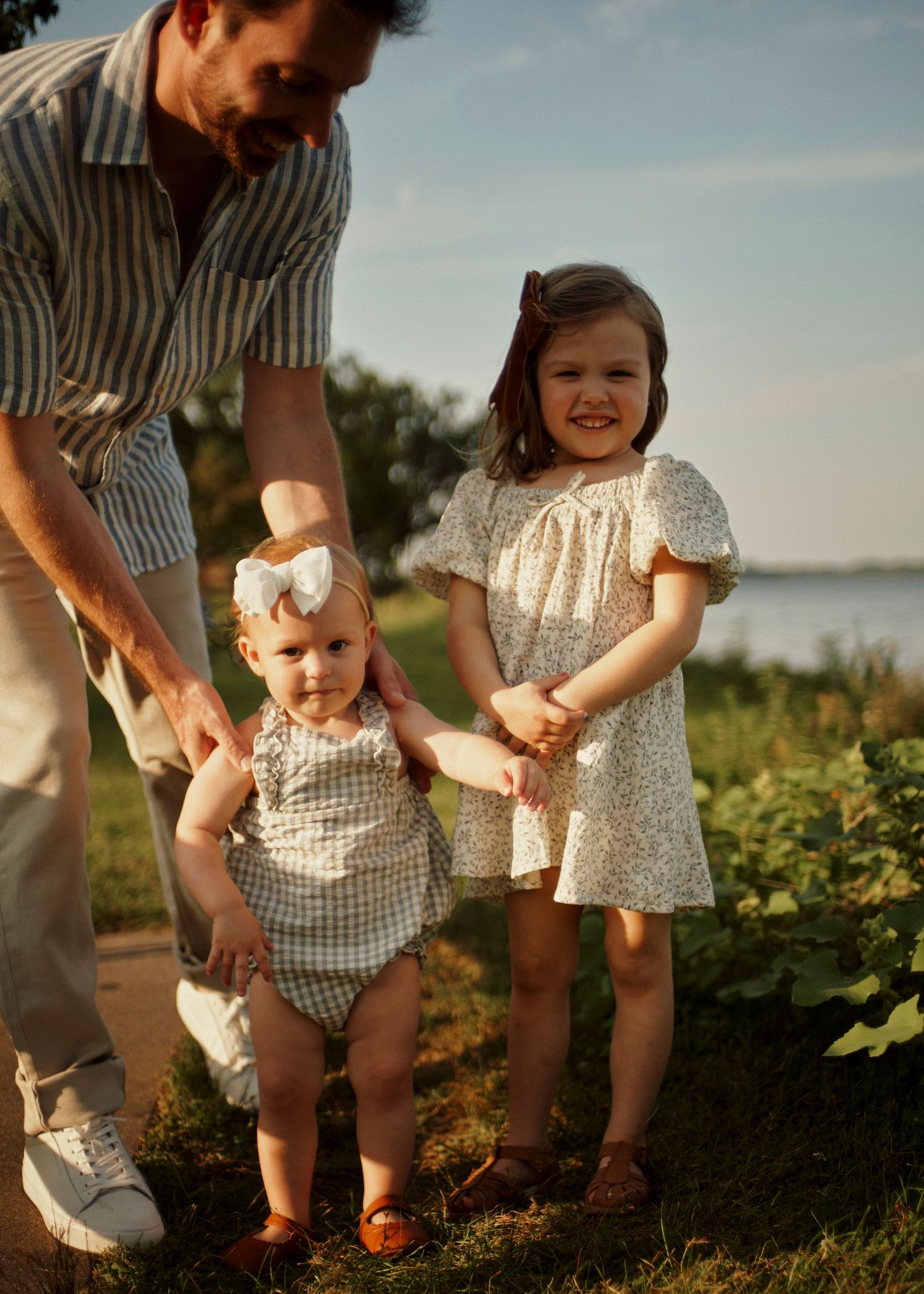 Family picking fruits together in a garden during a warm summer evening.