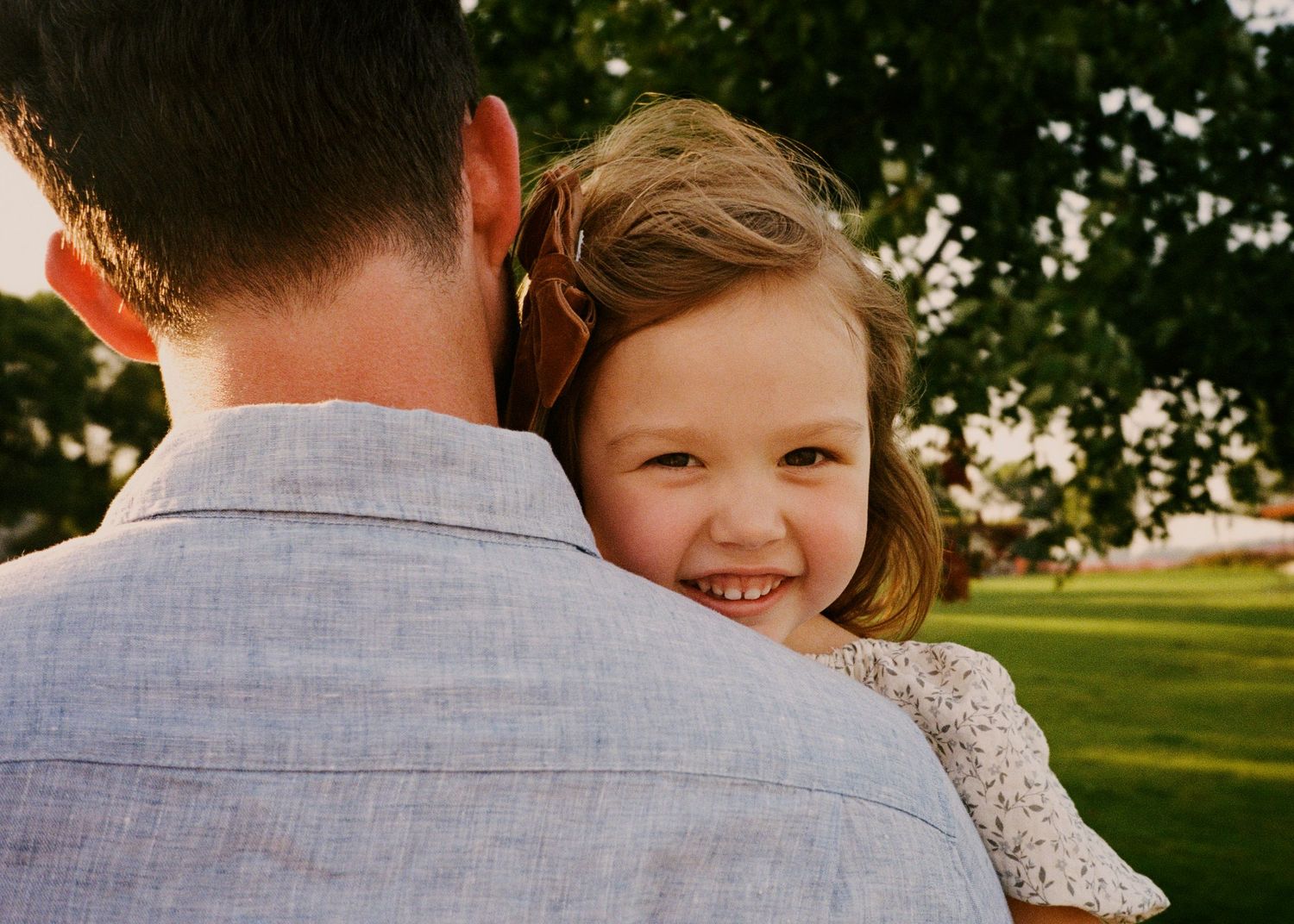 Candid family interactions captured during an outdoor photo session.