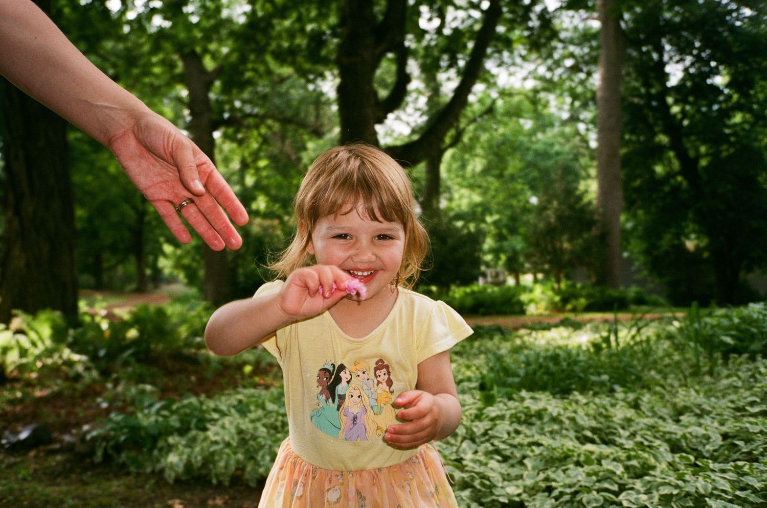 Joyful outdoor scene in a lush green garden setting during summer.