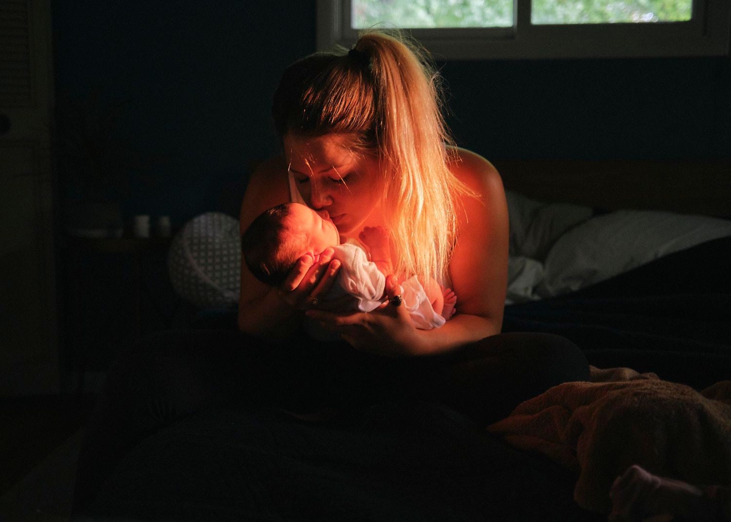 A dark and moody series of candlelit portraits showing dramatic shadows and warm orange glows.