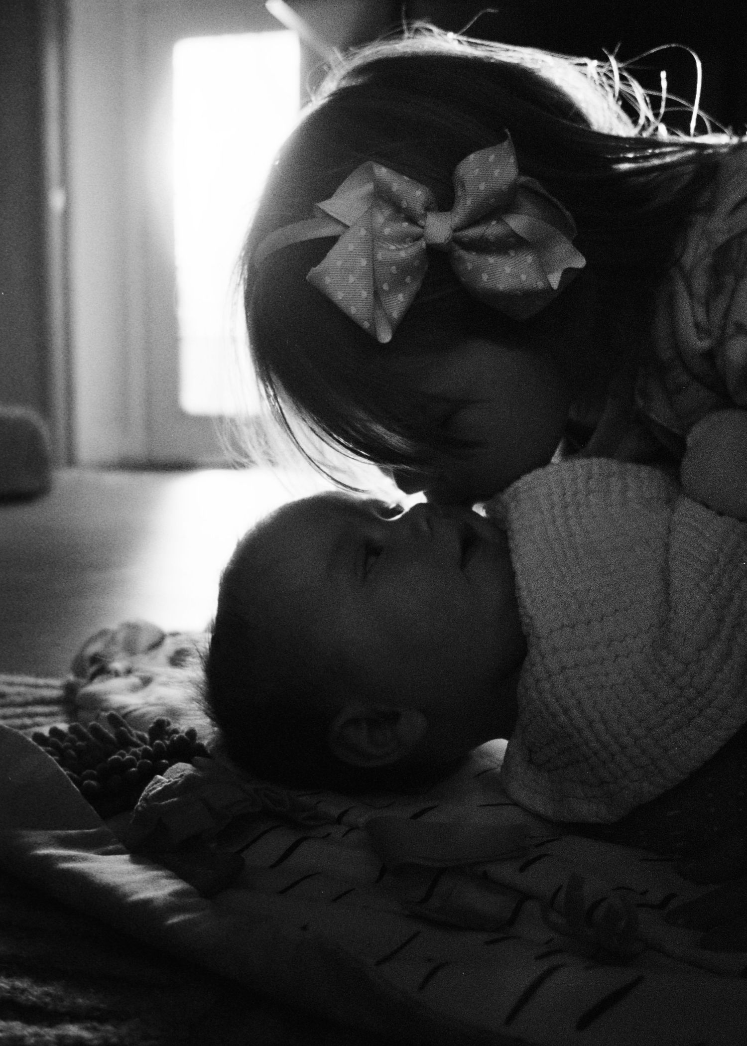 Black and white indoor photos showing silhouettes and soft window lighting.