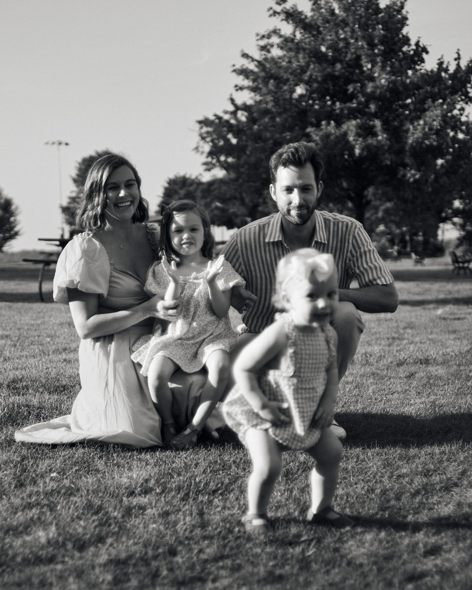 Black and white family photo sequence showing playful interactions outdoors.