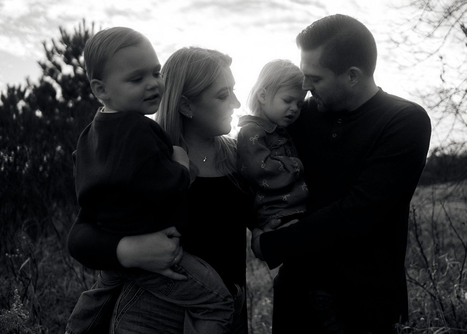 Black and white family portraits showing joyful expressions and natural interactions.