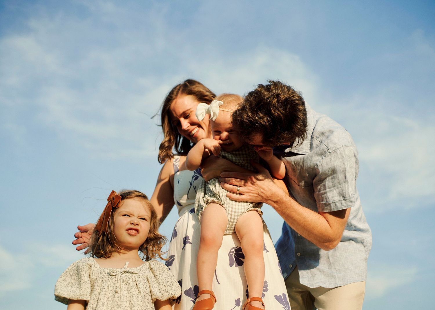 A joyful family moment captured against a bright blue sky.