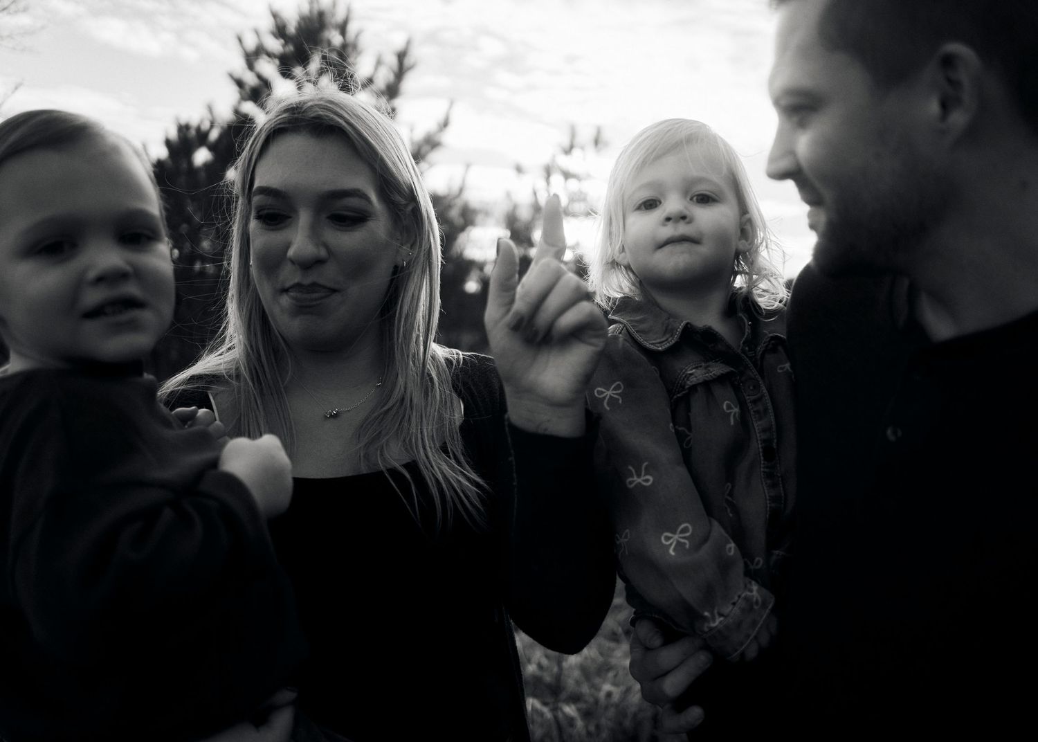 Black and white candid shots showing playful family interactions.
