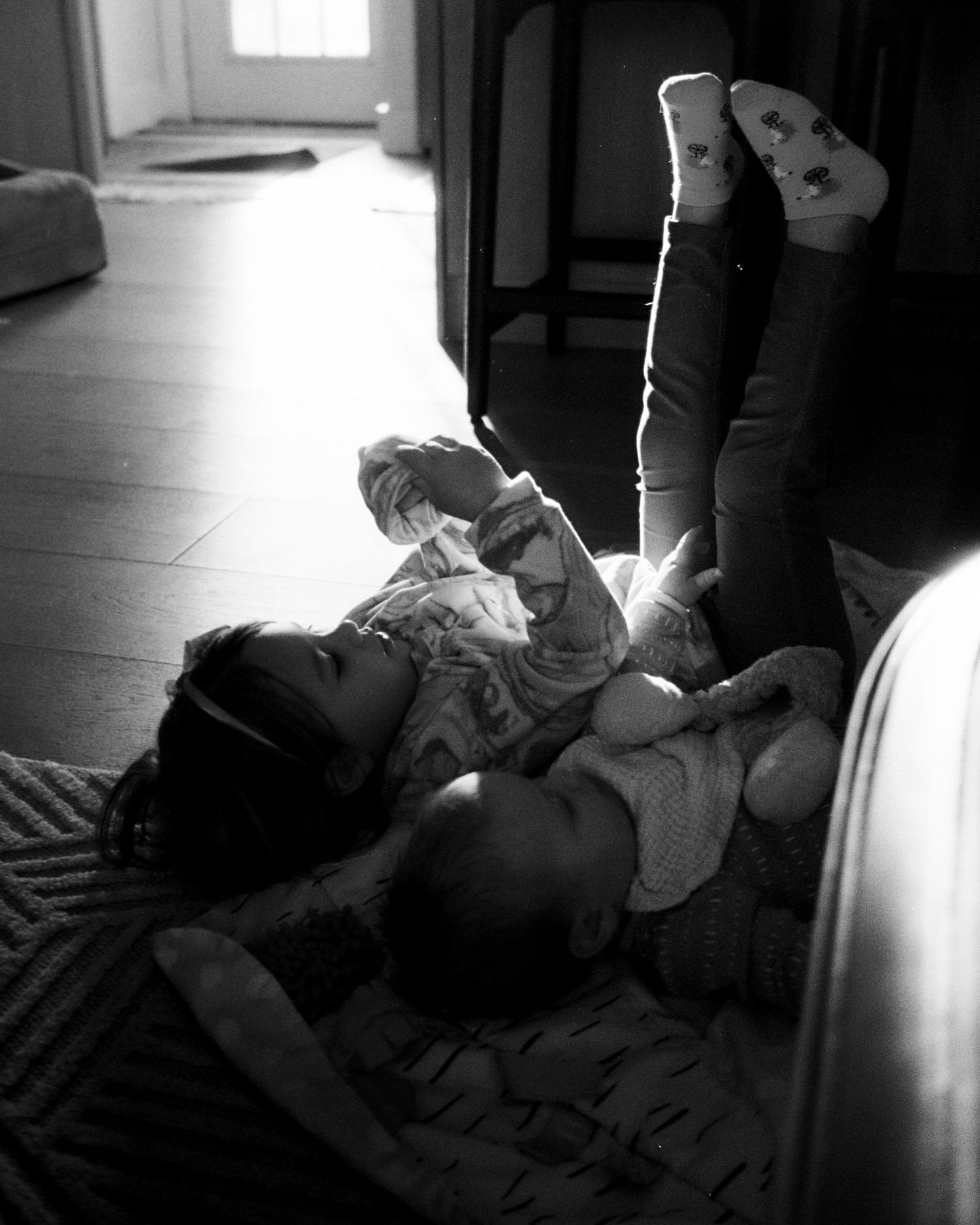 Black and white indoor photos with dramatic window lighting and shadows.