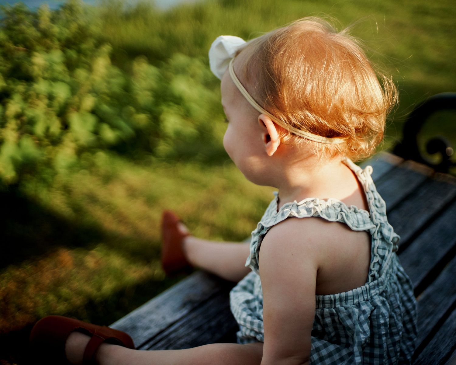 Casual outdoor family portraits with natural sunlight filtering through trees.