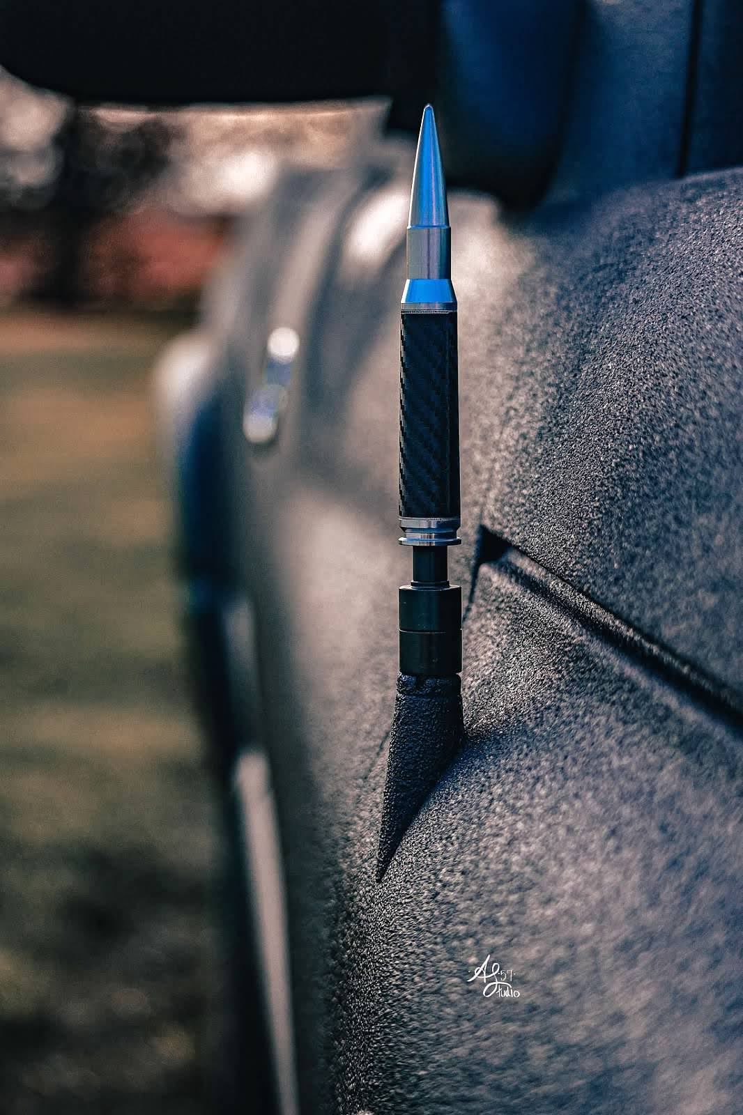 Macro photography of blue fountain pen nibs with water droplets.
