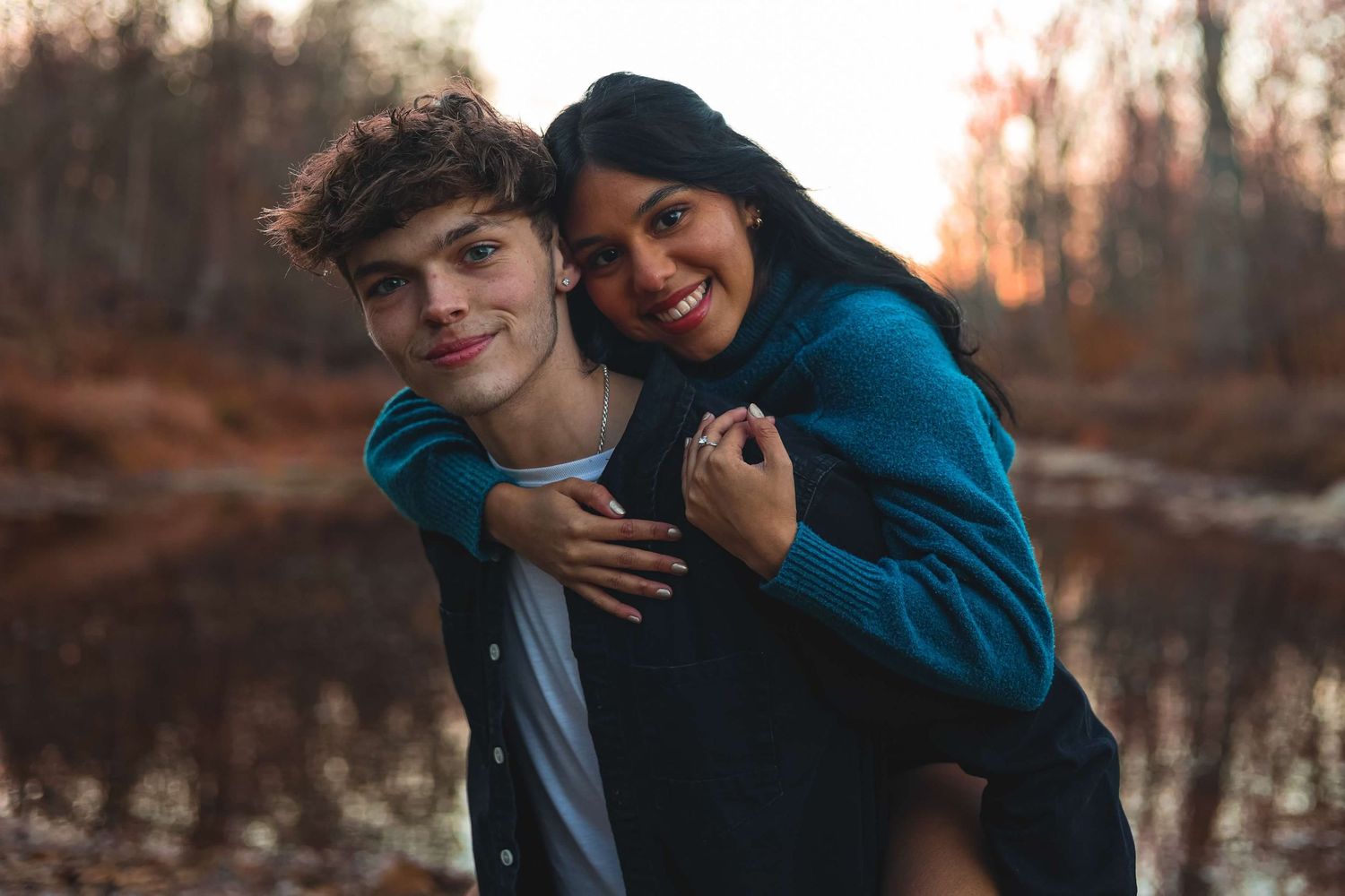 Couple sharing intimate moment during sunset photo session outdoors.