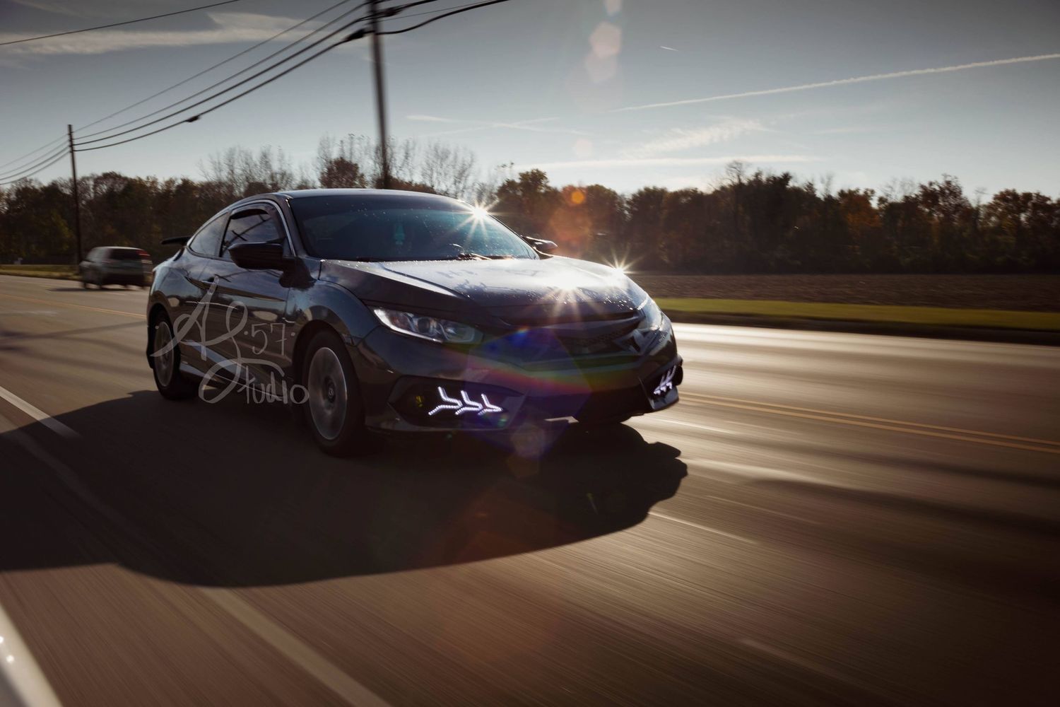 Dynamic motion shots of a sports car on suburban roads at dusk.