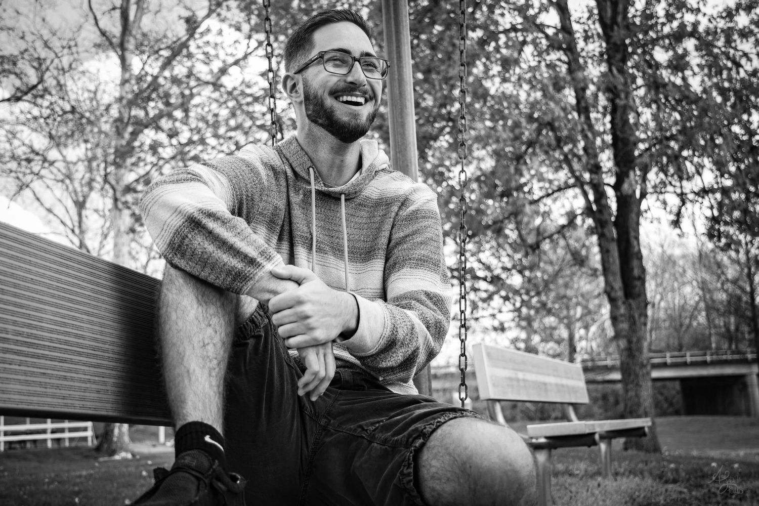 Candid outdoor photoshoot with natural lighting and trees in background.
