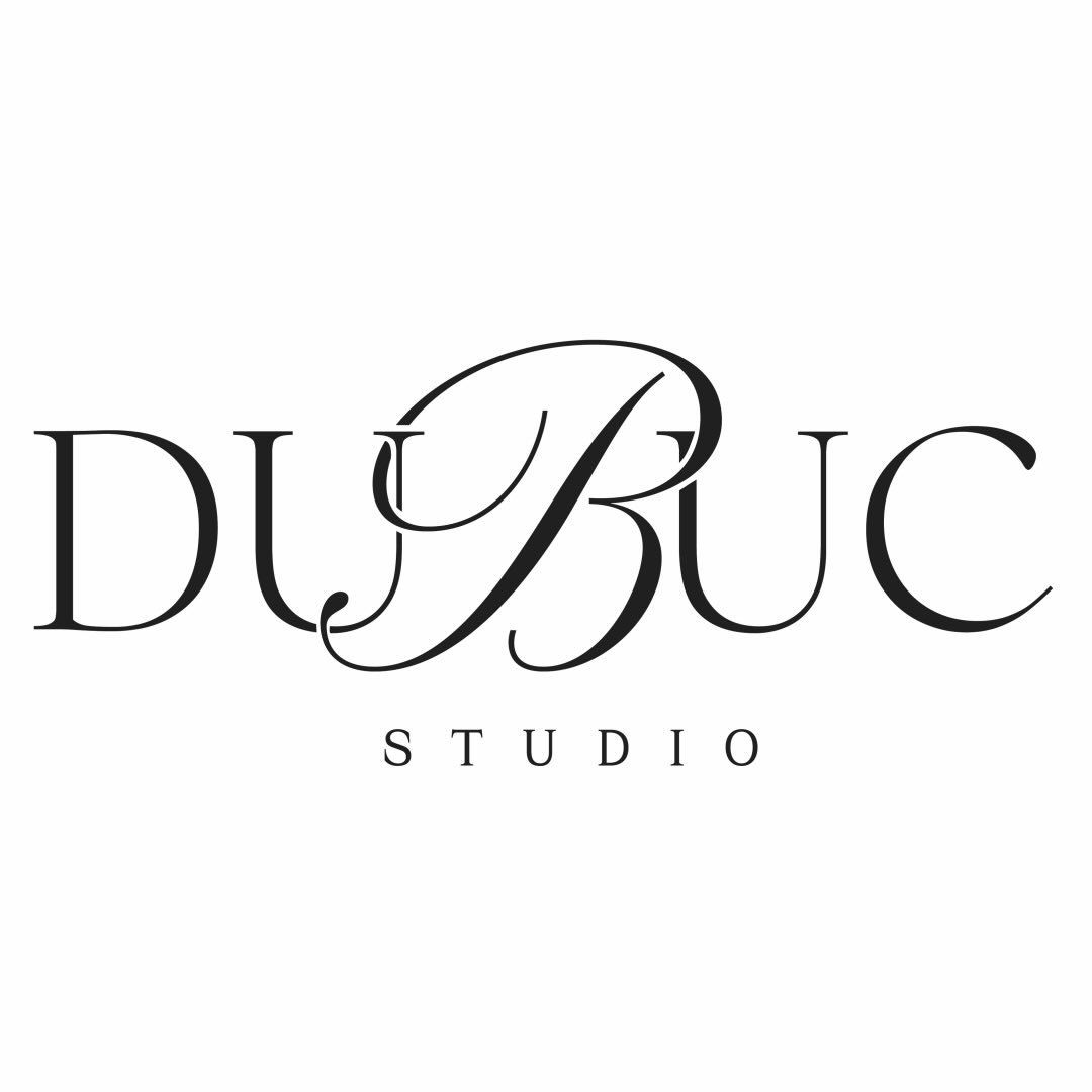 Dubuc Studio elegant black and white logo with ornate script lettering on white background.