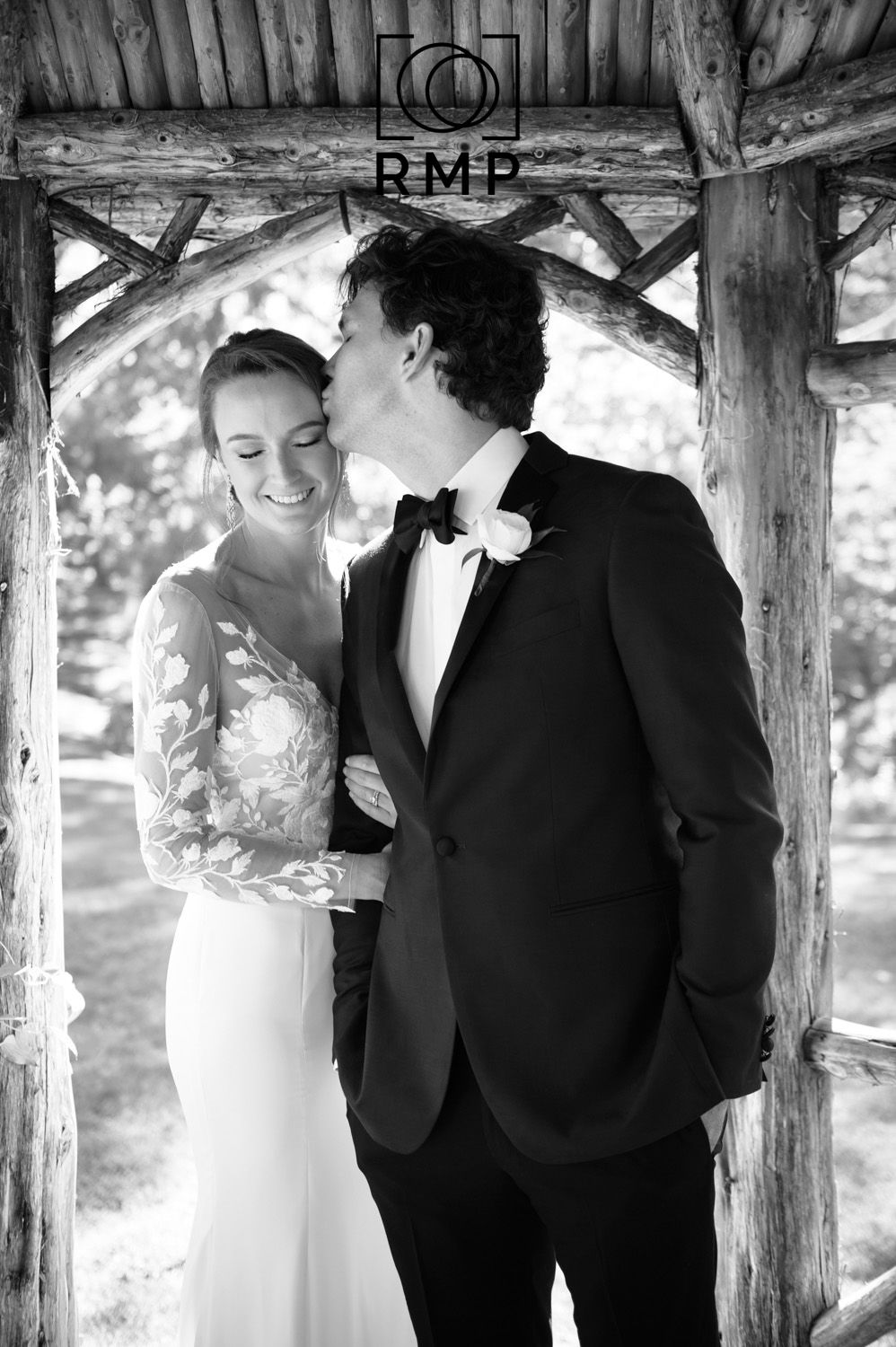 Destination Maryland wedding. Rachel Mares Photography. Black & White photo of couple in gazebo. Groom kissing the brides forehead