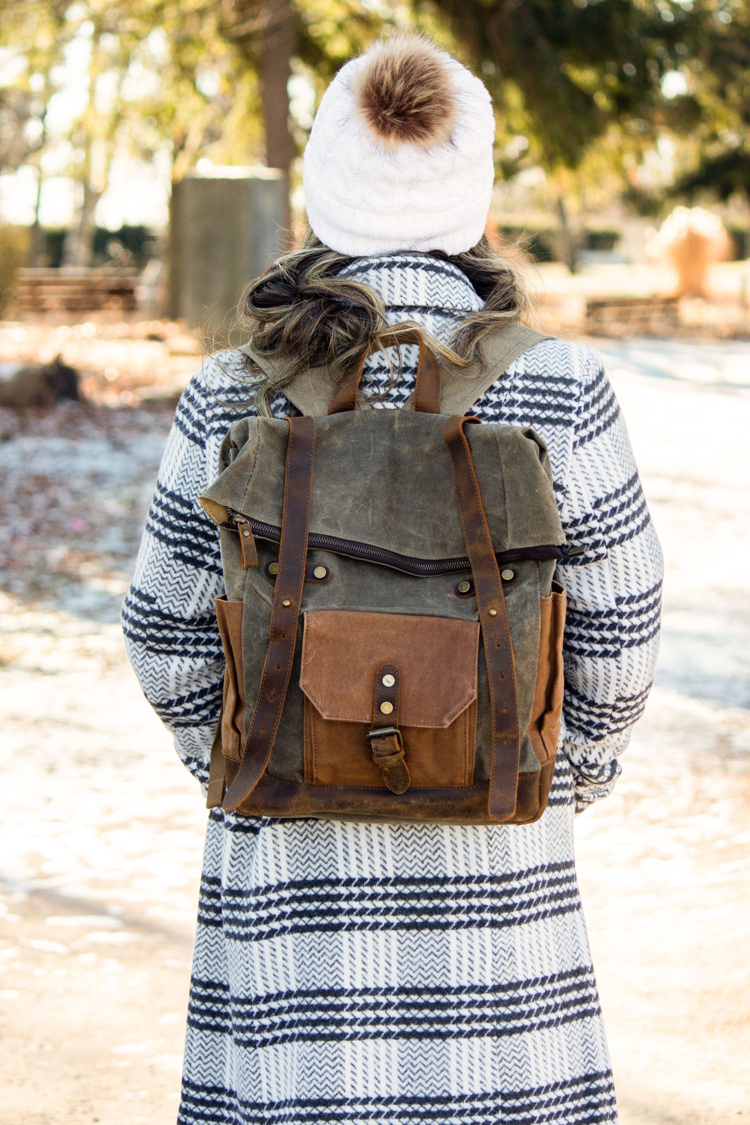 Toronto Product Photographer - Person wearing patterned sweater carrying brown leather messenger bag in winter setting.