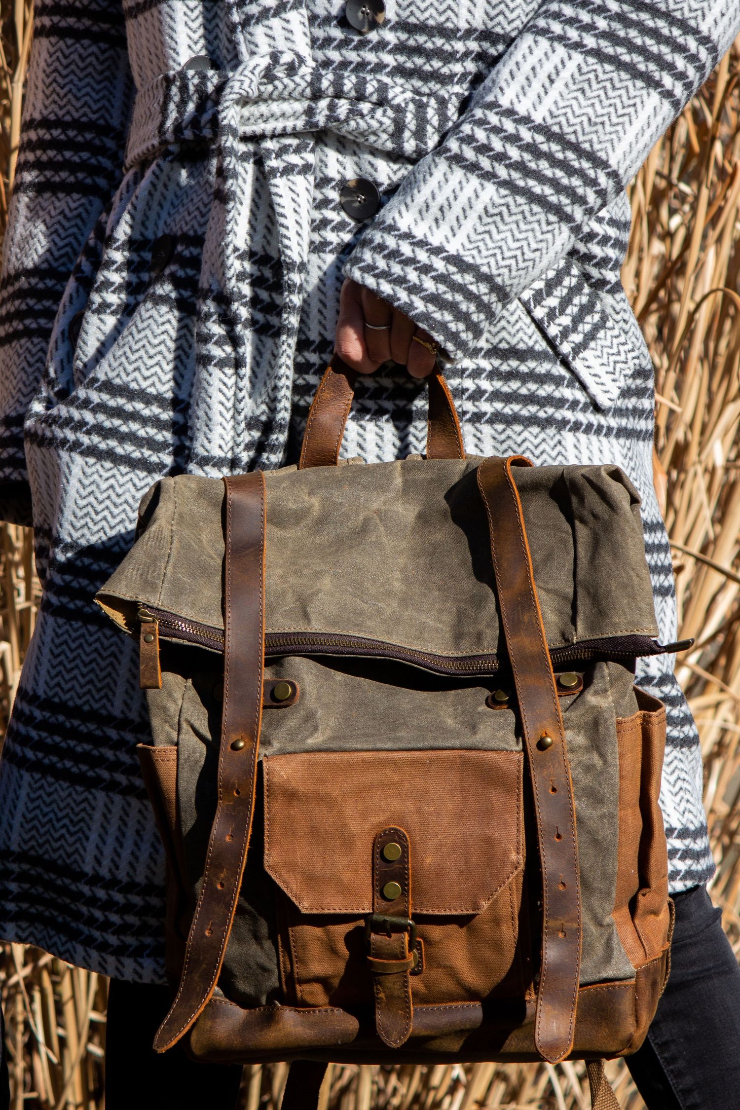 Toronto Product Photographer - Vintage-style messenger bag in brown and grey canvas with leather straps displayed outdoors.