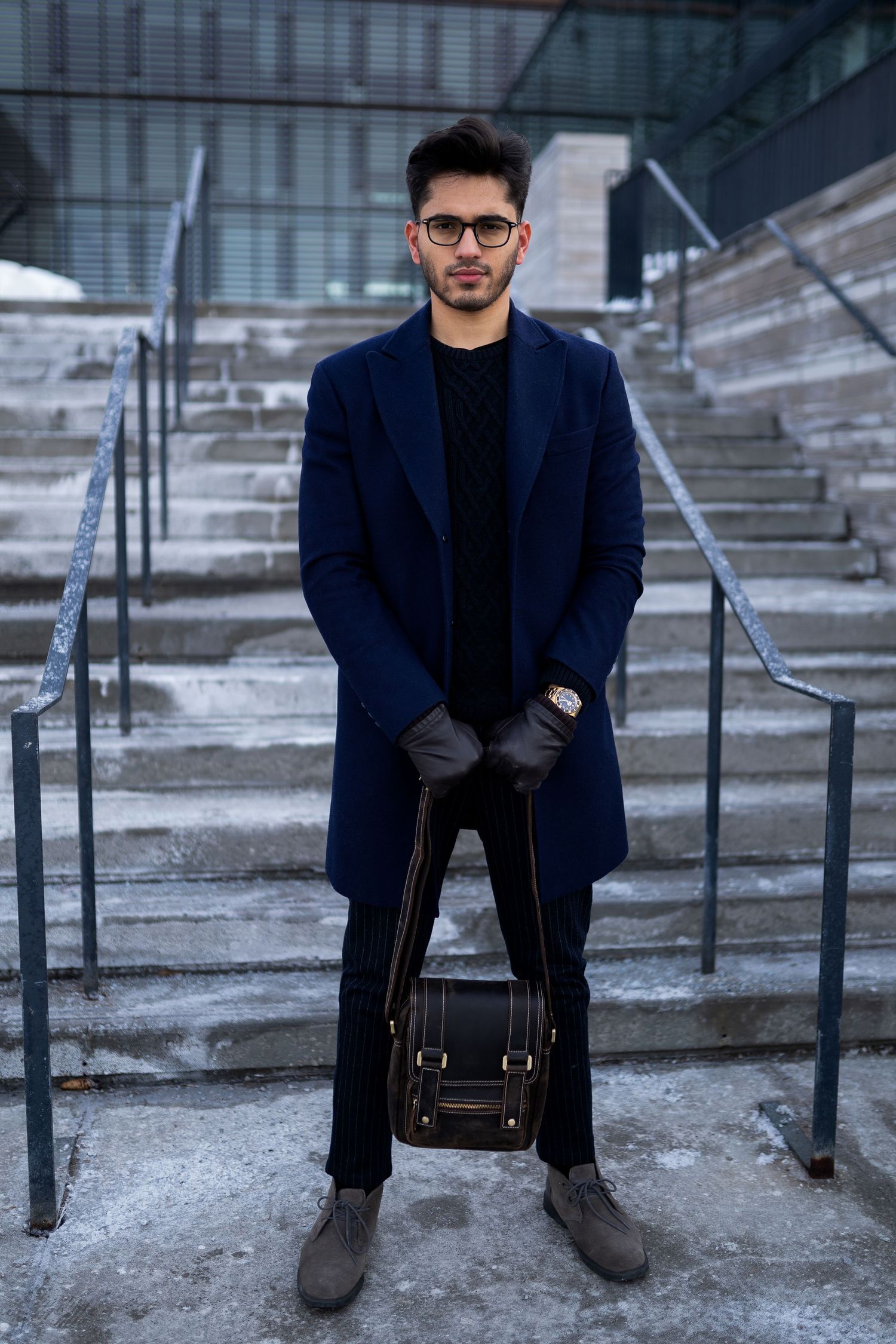 Toronto Portrait Photographer - Winter fashion look featuring navy coat and brown leather bag on snowy steps.