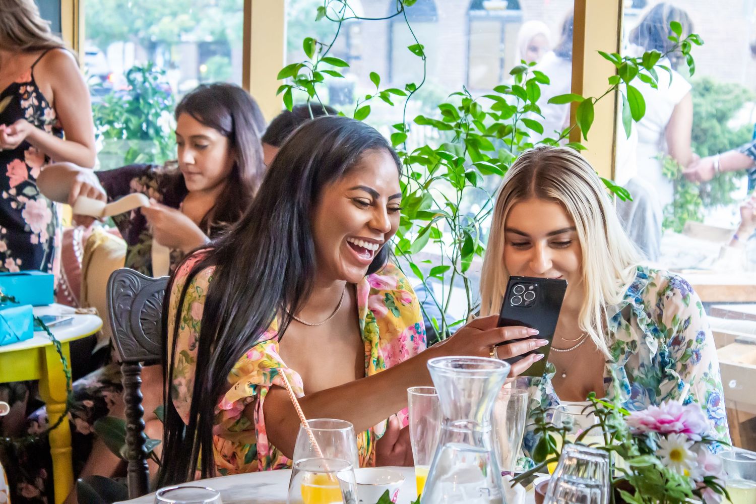 Toronto Event Photographer - Group enjoying a festive outdoor dining celebration with drinks and laughter.