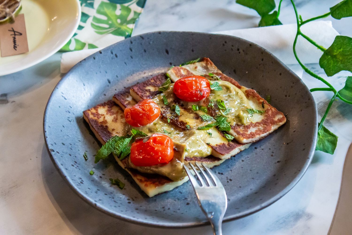 Toronto Event Photographer - Bruschetta appetizers garnished with fresh tomatoes and herbs served on dark plates.