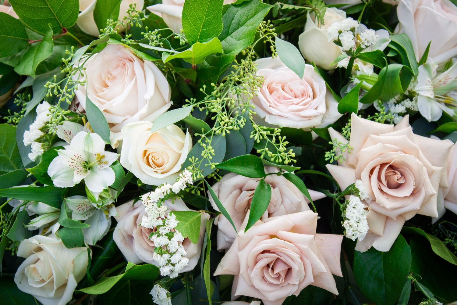 Toronto Event Photographer - Romantic floral arrangement featuring blush roses and white flowers with lush greenery.