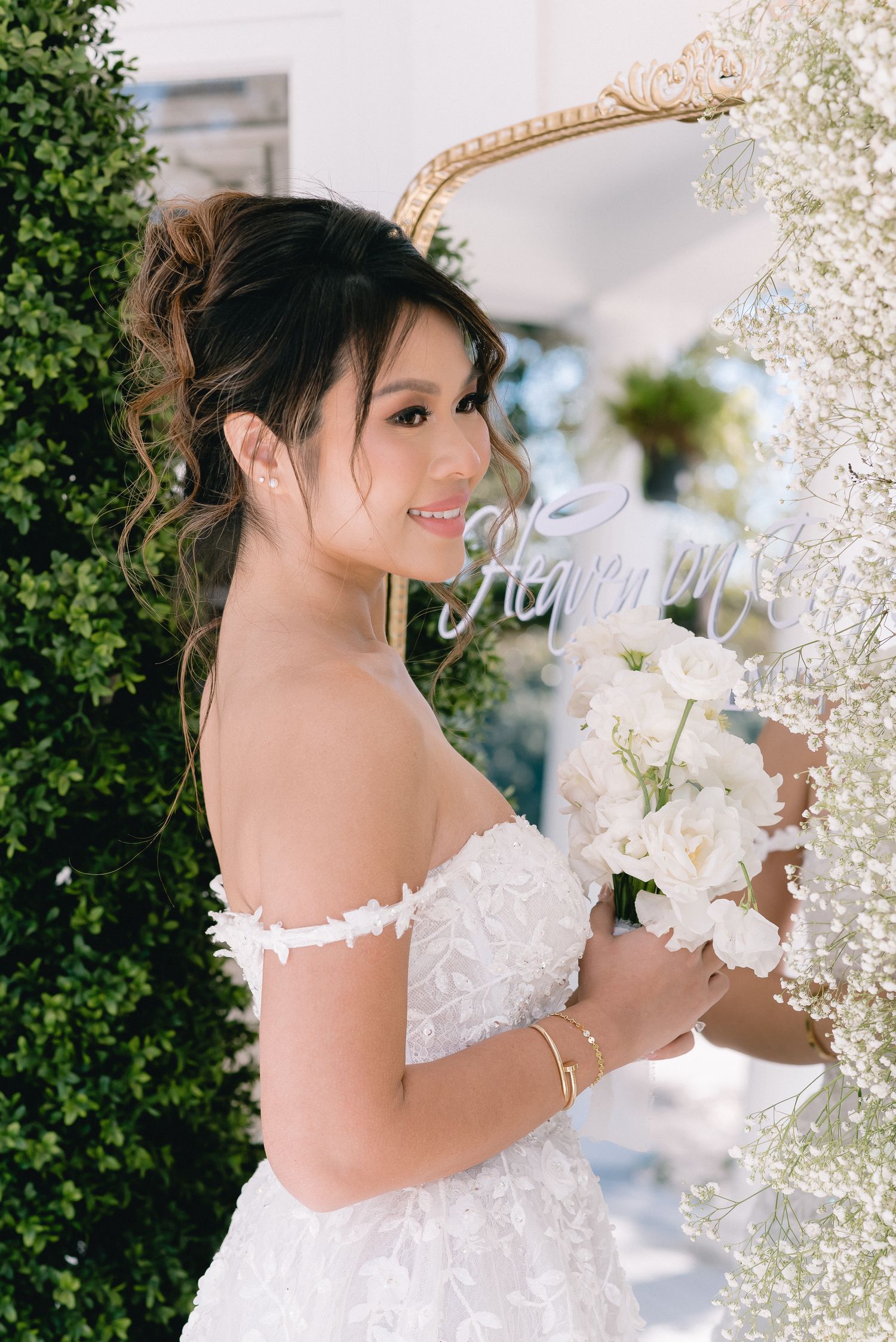 White wedding gown details with lace and floral elements against a garden backdrop.