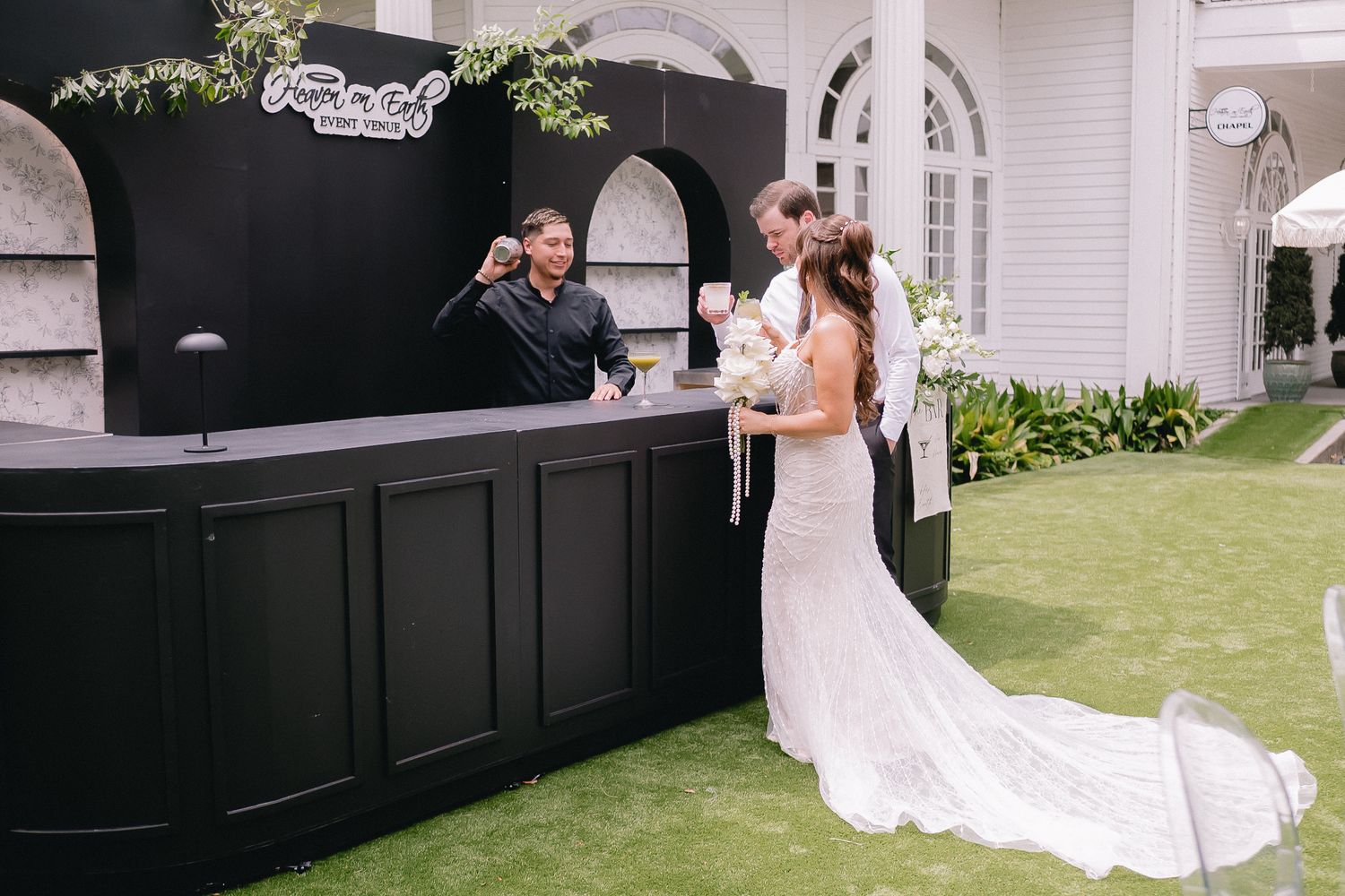 Elegant black and white exterior wedding venue setting with traditional architectural details.