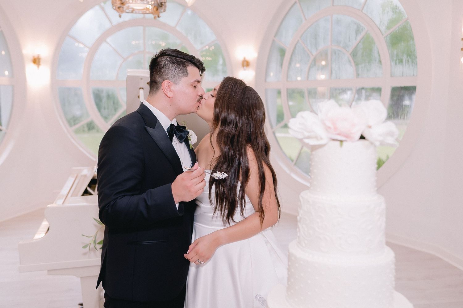 Romantic wedding celebration moment in an elegant white ballroom.